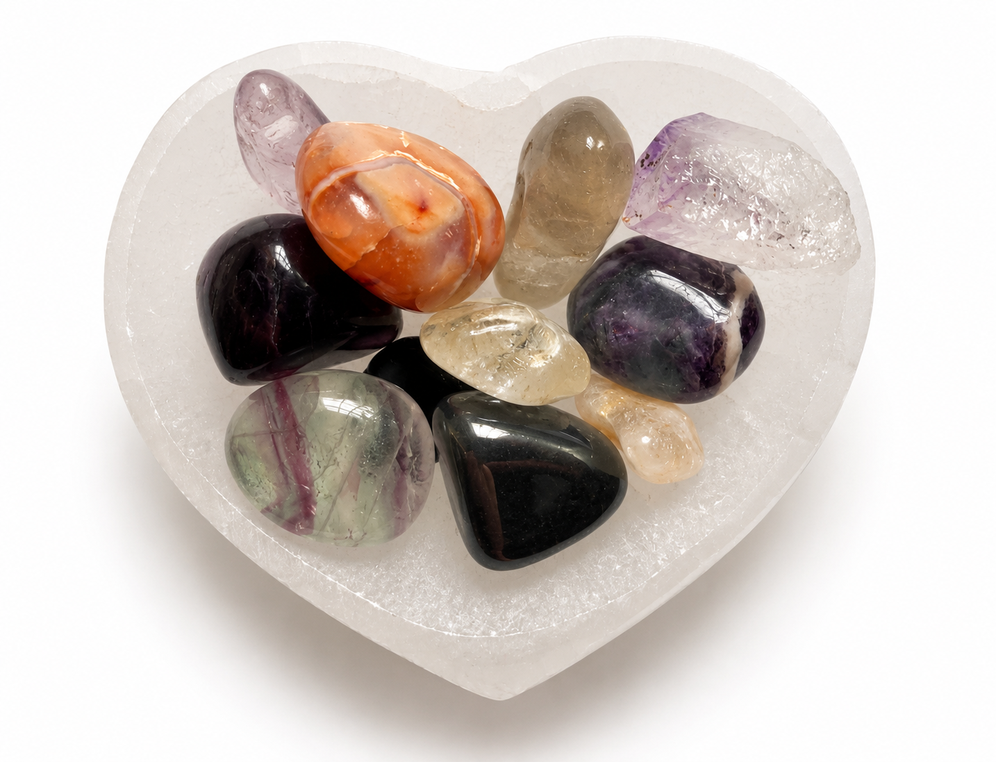 Polished crystals in a heart-shaped stone bowl.