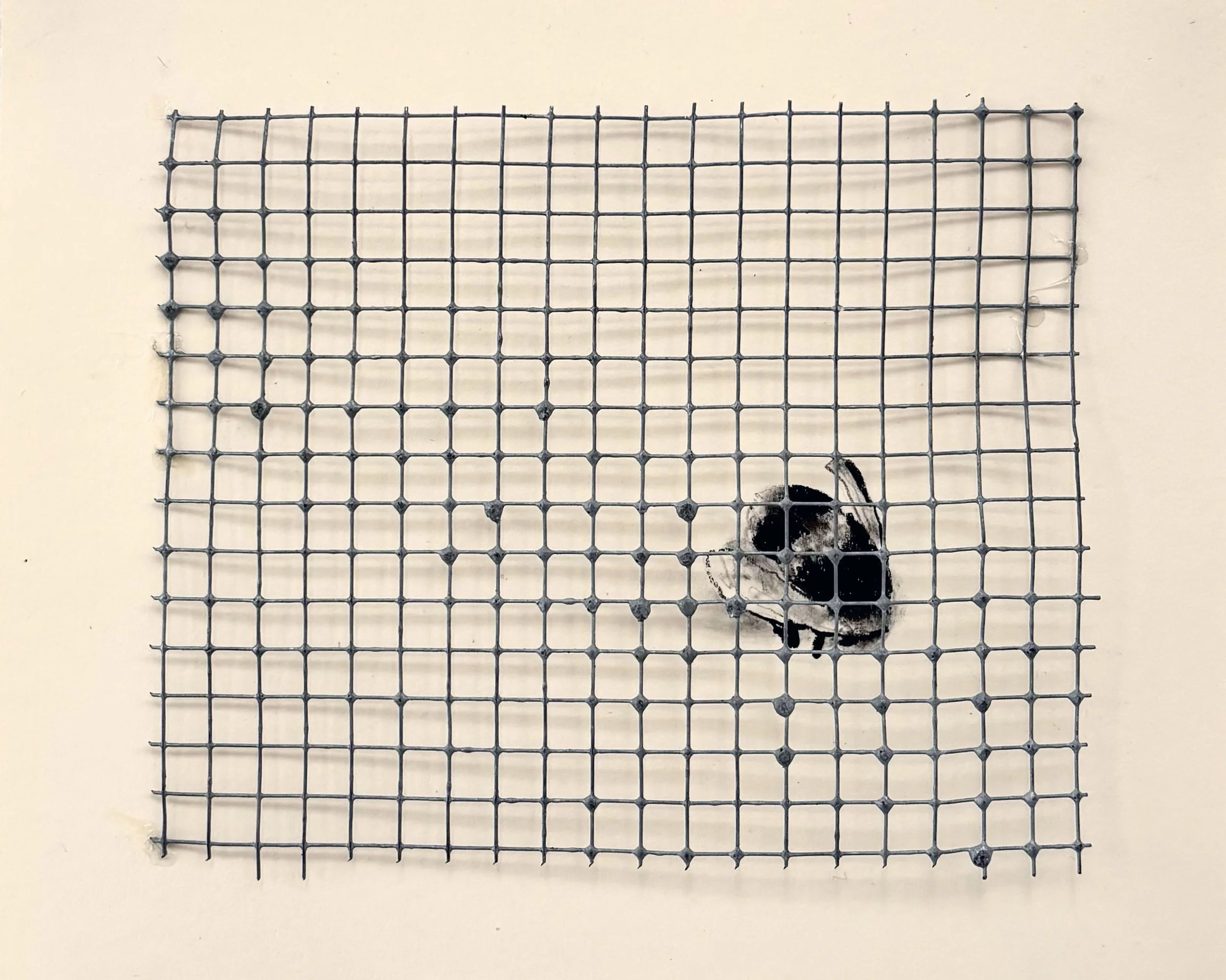 A metal grid mounted on a beige square of paper with a small bee drawing underneath it.