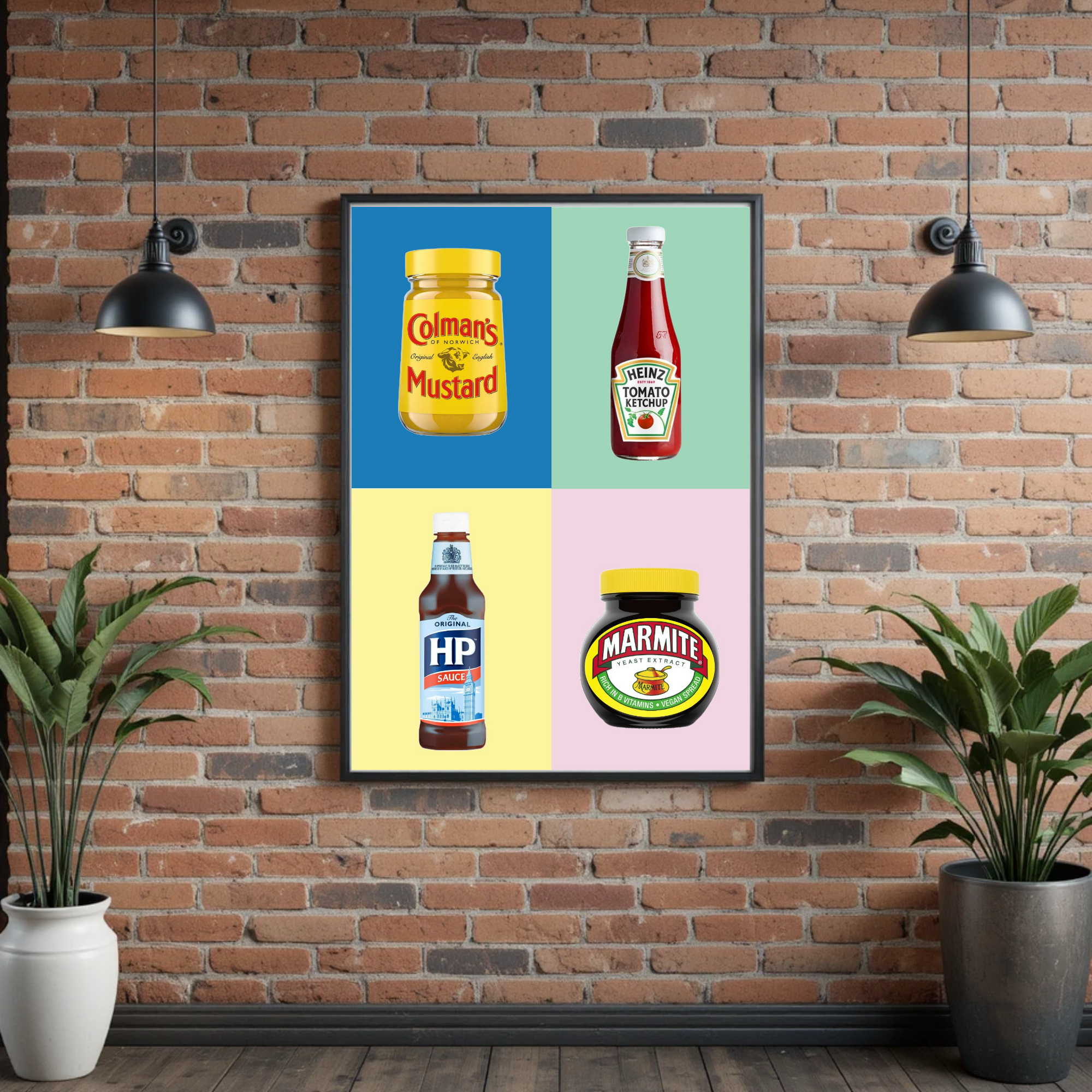 A framed poster on a brick wall featuring images of mustard and ketchup bottles. The mustard bottle is yellow with a yellow cap and labeled 'Colman's Mustard.' The ketchup bottle is red with a white cap and labeled 'Heinz Tomato Ketchup.' The poster has a colorful background with blue, green, yellow, and pink sections. Two black hanging lamps are positioned above the poster, and there are two potted plants, one white and one black, at the bottom corners of the image.