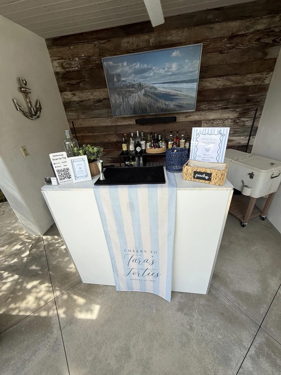 Custom mobile bar setup with signature cocktail menu at a private event