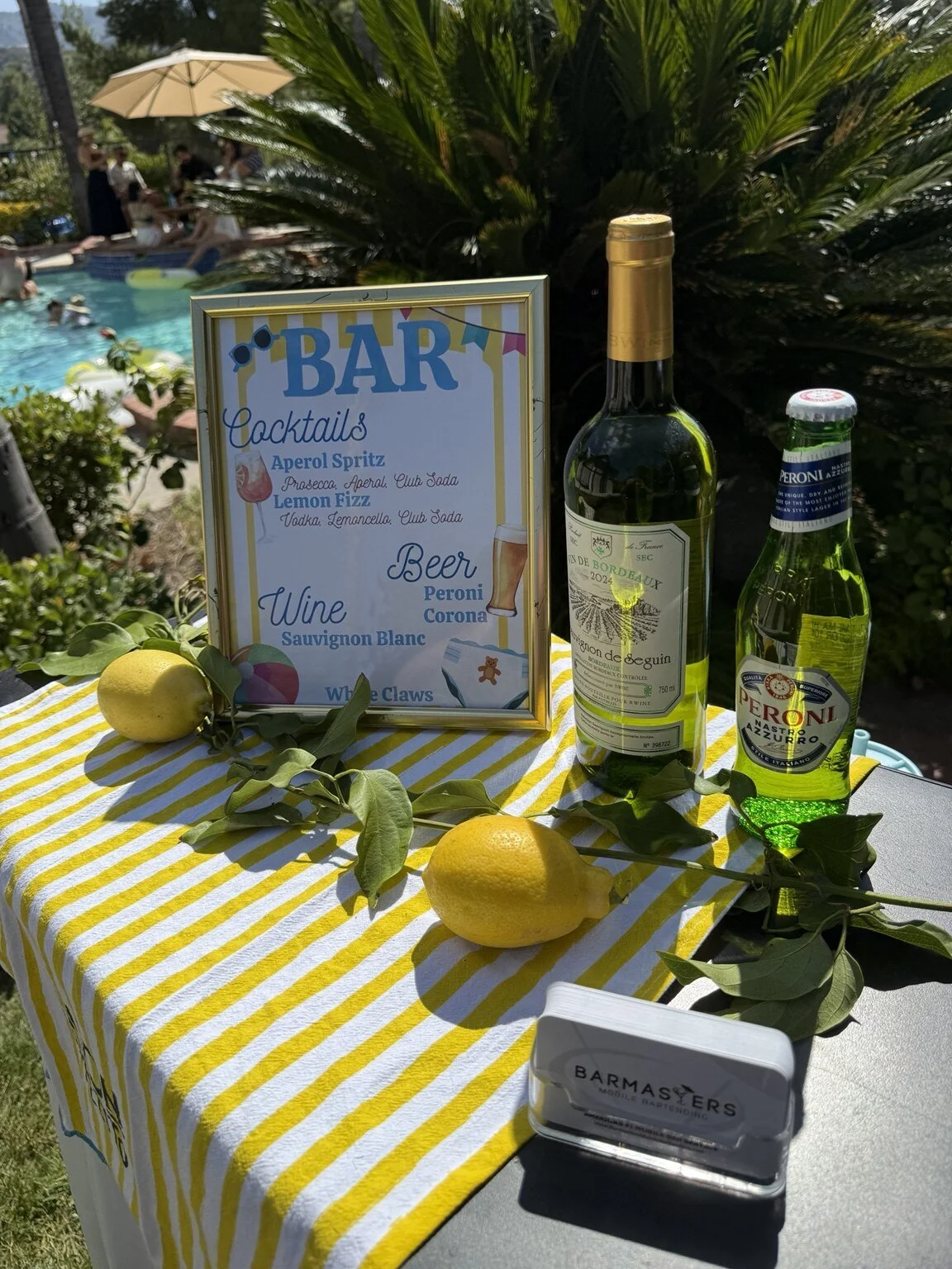 Custom poolside bar setup with signature cocktail menu and event service