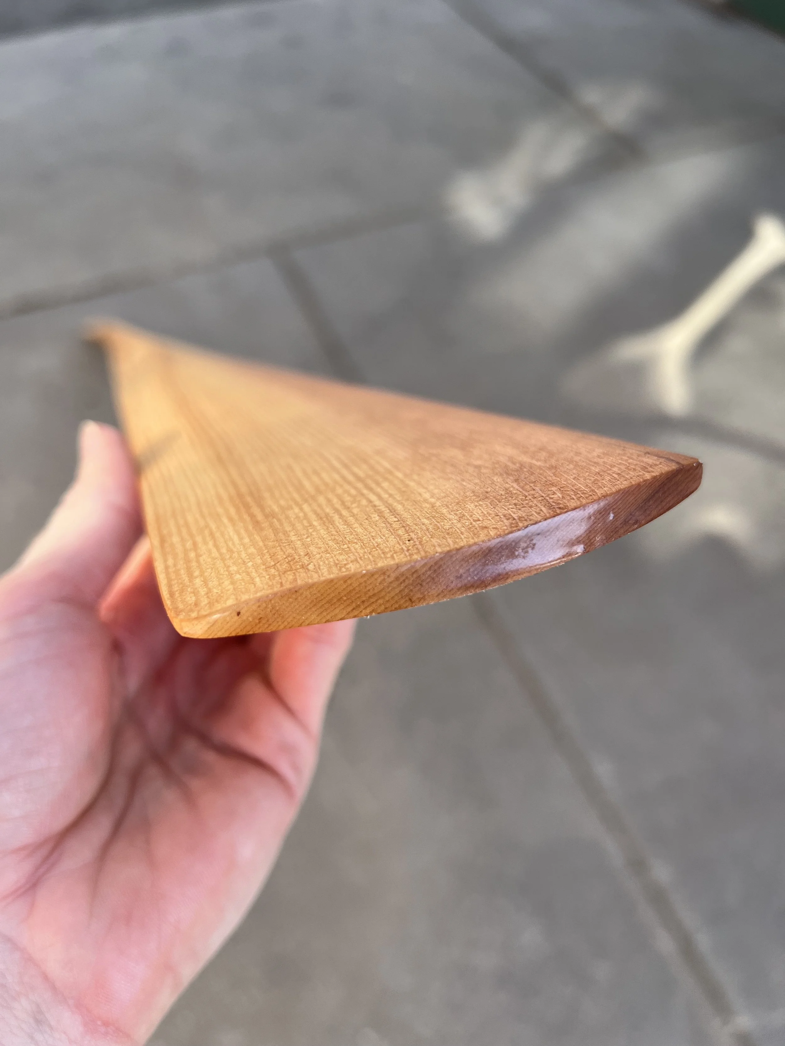 A person holding a Western Red Cedar Traditional Greenland Paddle