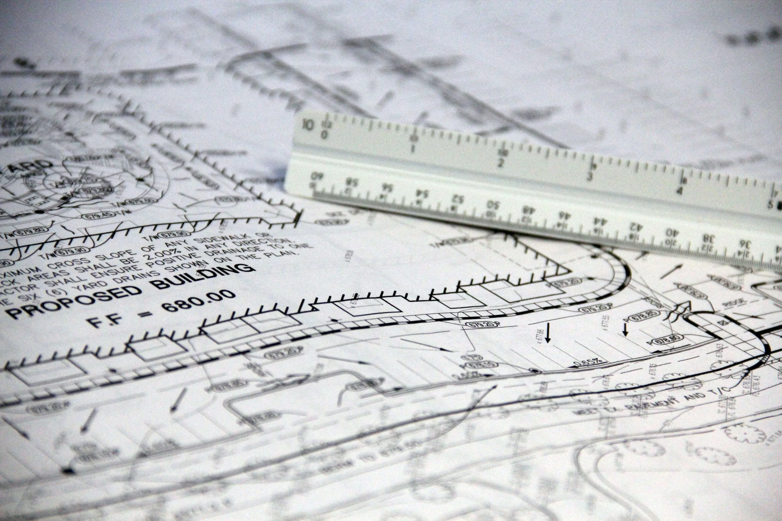 Civil engineering site plan with an engineering scale on top.
