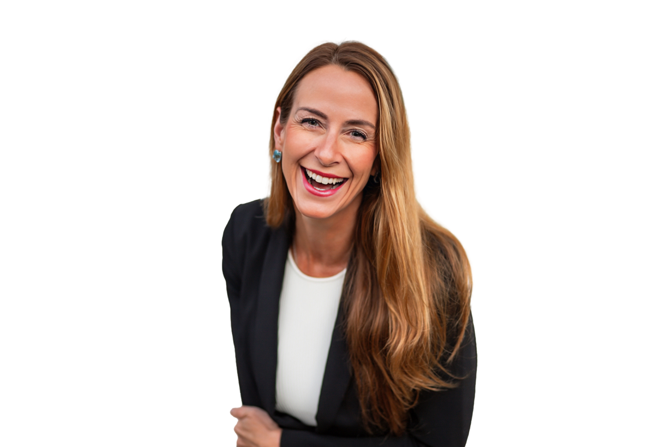 A woman with long red hair, wearing a black blazer and white top, smiling and laughing.
