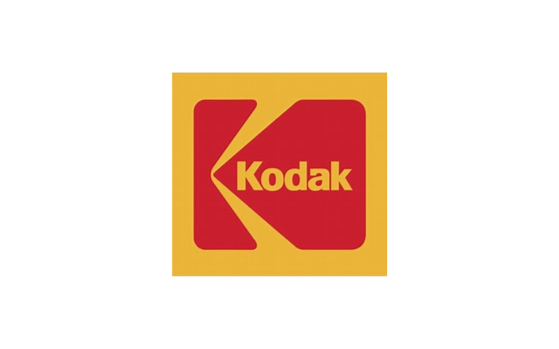 A vintage Kodak logo with a red and yellow design, featuring the word 'Kodak' inside a stylized film reel icon.