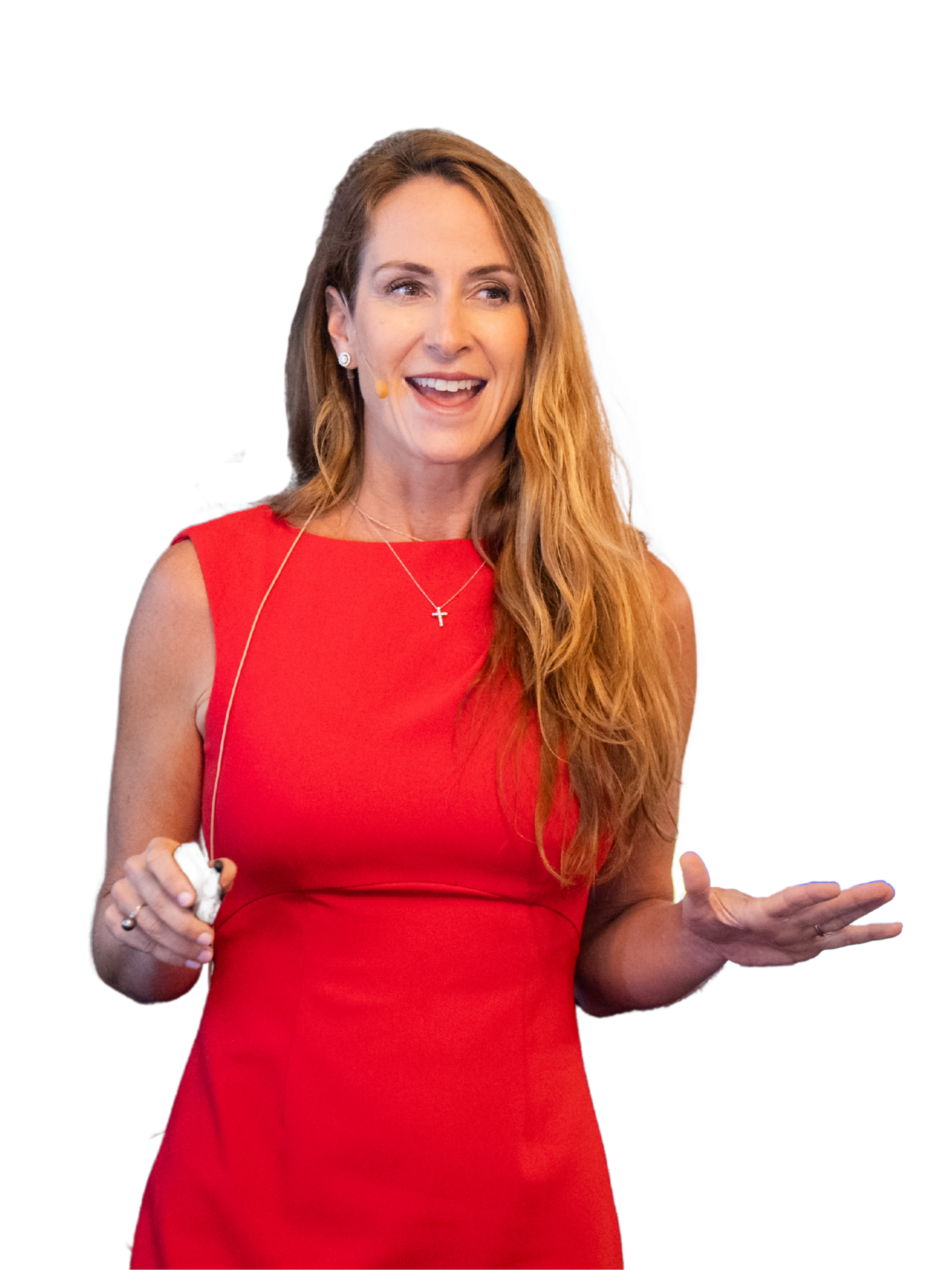 A woman in a sleeveless red dress speaking at a conference, holding a remote control in her right hand, with a cheerful expression.