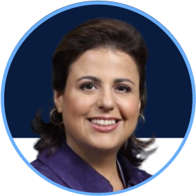 Professional woman with dark hair, smiling, wearing a purple blazer against a blue and white background.
