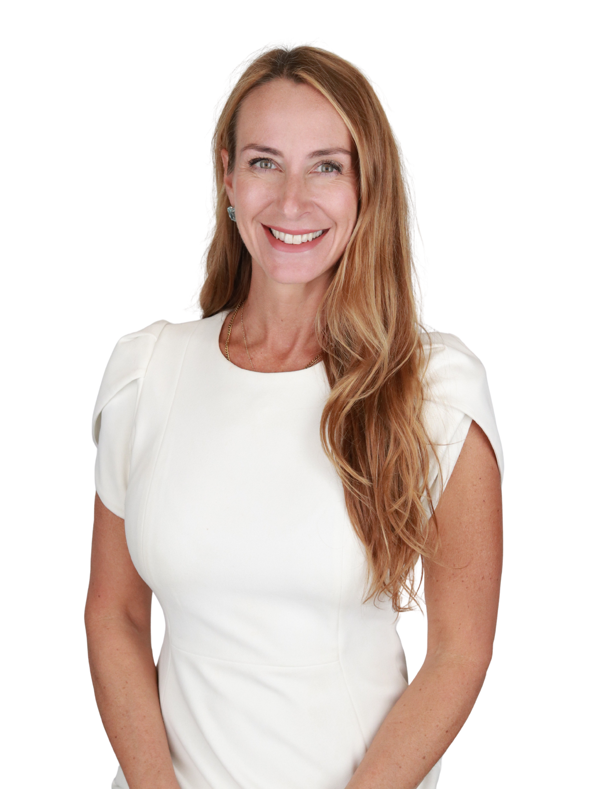A woman with long, wavy red hair smiling while wearing a white dress.