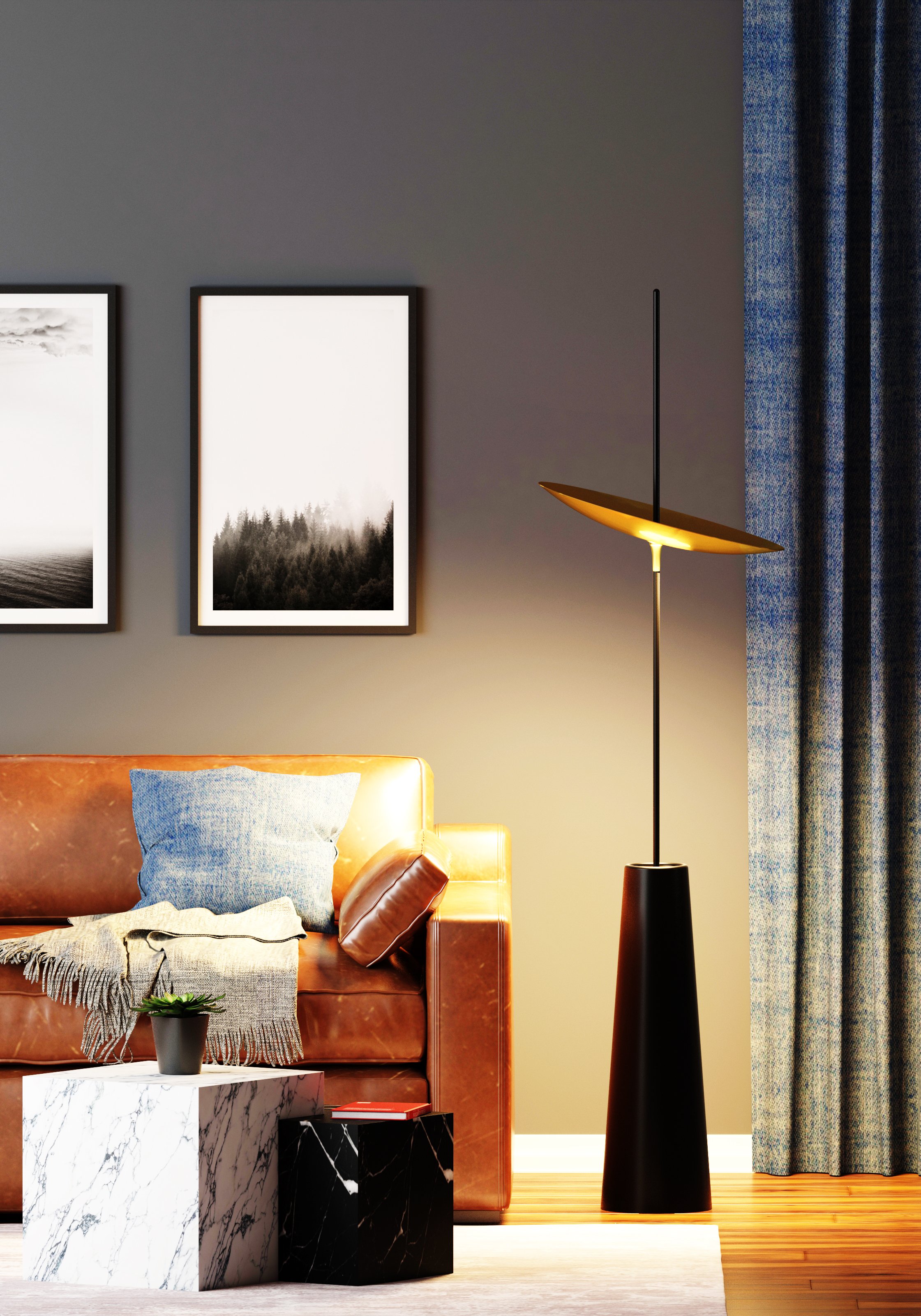 Living room corner with a leather sofa, throw pillows, a small marble side table with a plant, framed black and white landscape photographs on the wall, a modern floor lamp, blue curtains, and hardwood floors.