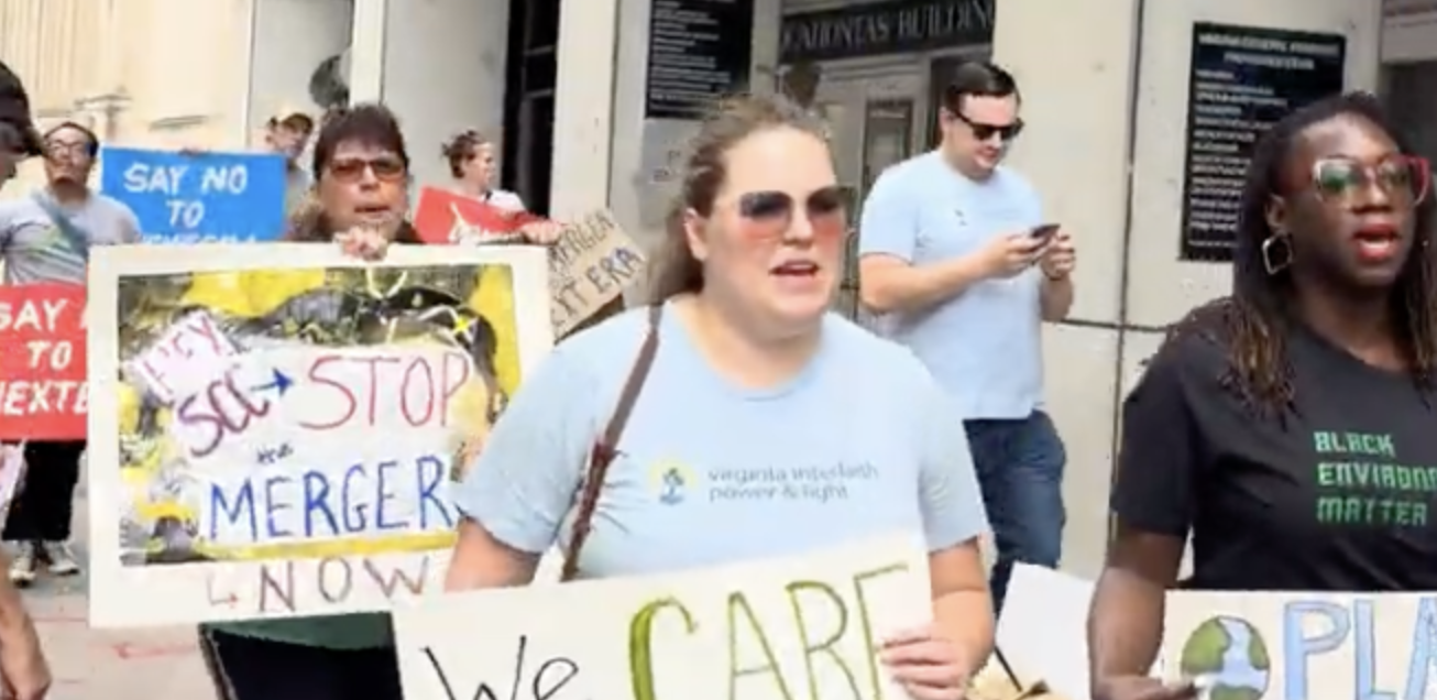 a group of people hold signs protesting the nextera/dominion merger