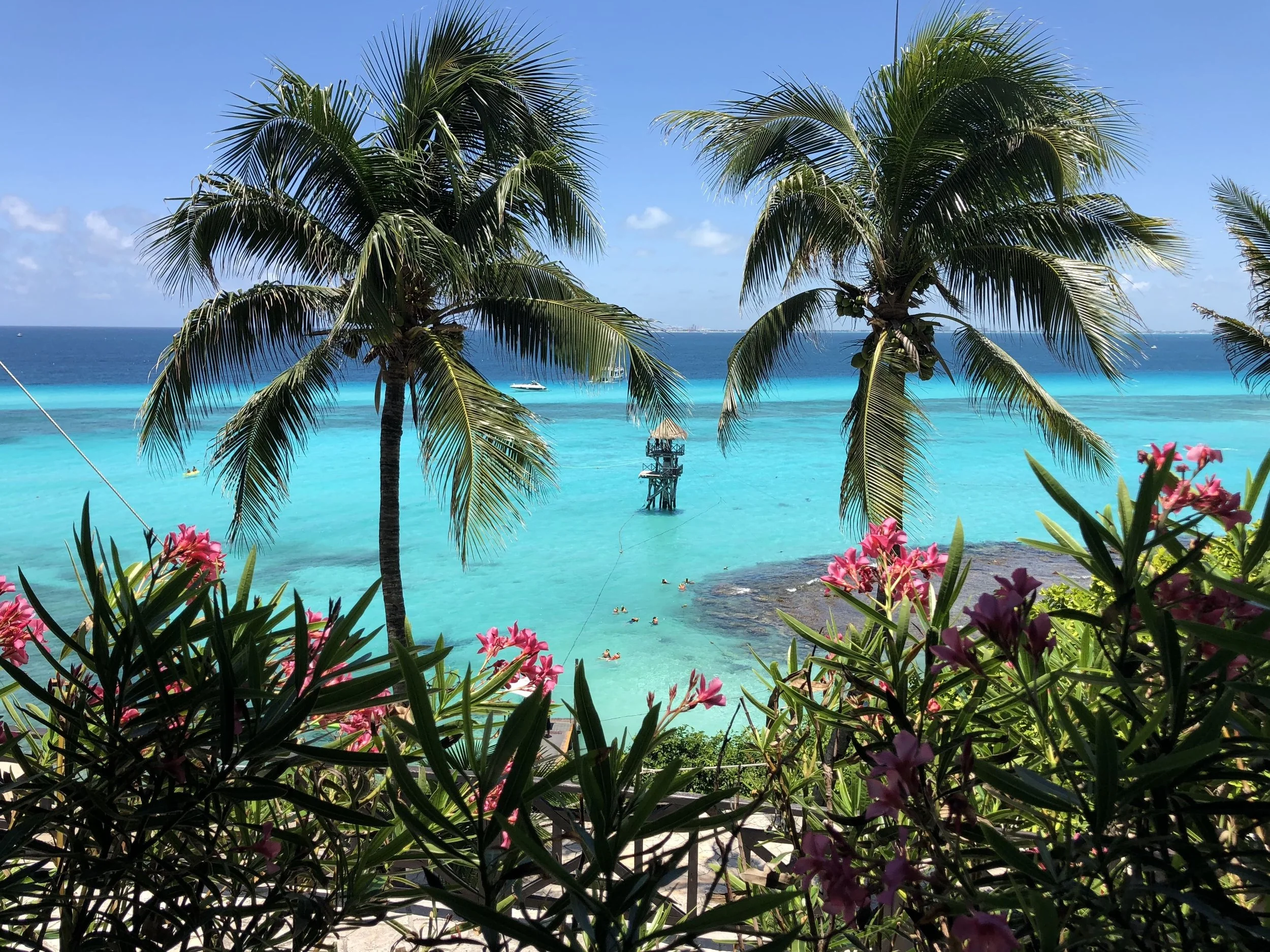 Tropical beach destination with turquoise Caribbean waters, a relaxing getaway experience planned by Travel with Lori Bush