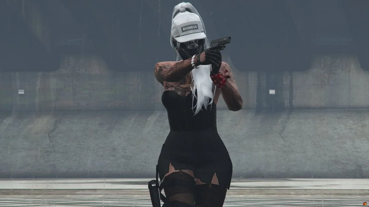A woman in a baseball cap, face mask, and gloves is pointing a handgun, with a large tattooed arm visible, in an industrial or urban area during daytime.