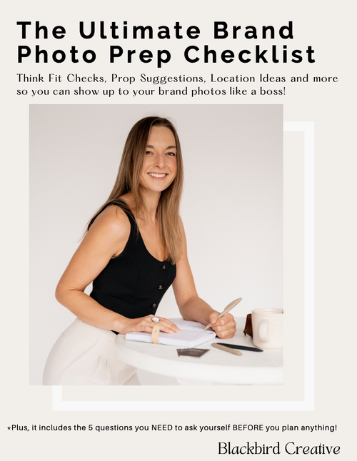 Cover of a guide titled 'The Ultimate Brand Photo Prep Checklist' featuring a smiling woman in a black sleeveless top and white pants holding a phone, sitting at a white table with notebooks, pen, and mug, on a plain background.