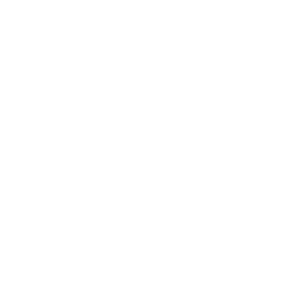 Two chairs facing each other with a small round table in between, and a microphone with wireless signals above it at the center.