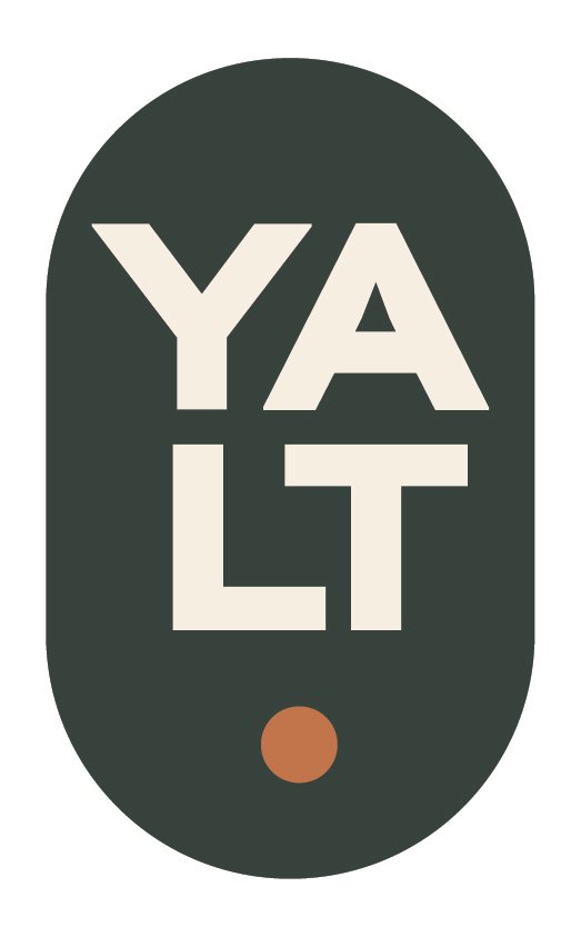 A vertical graphic with the word "YALT" inside a dark green oval shape, with a small brown circle at the bottom.