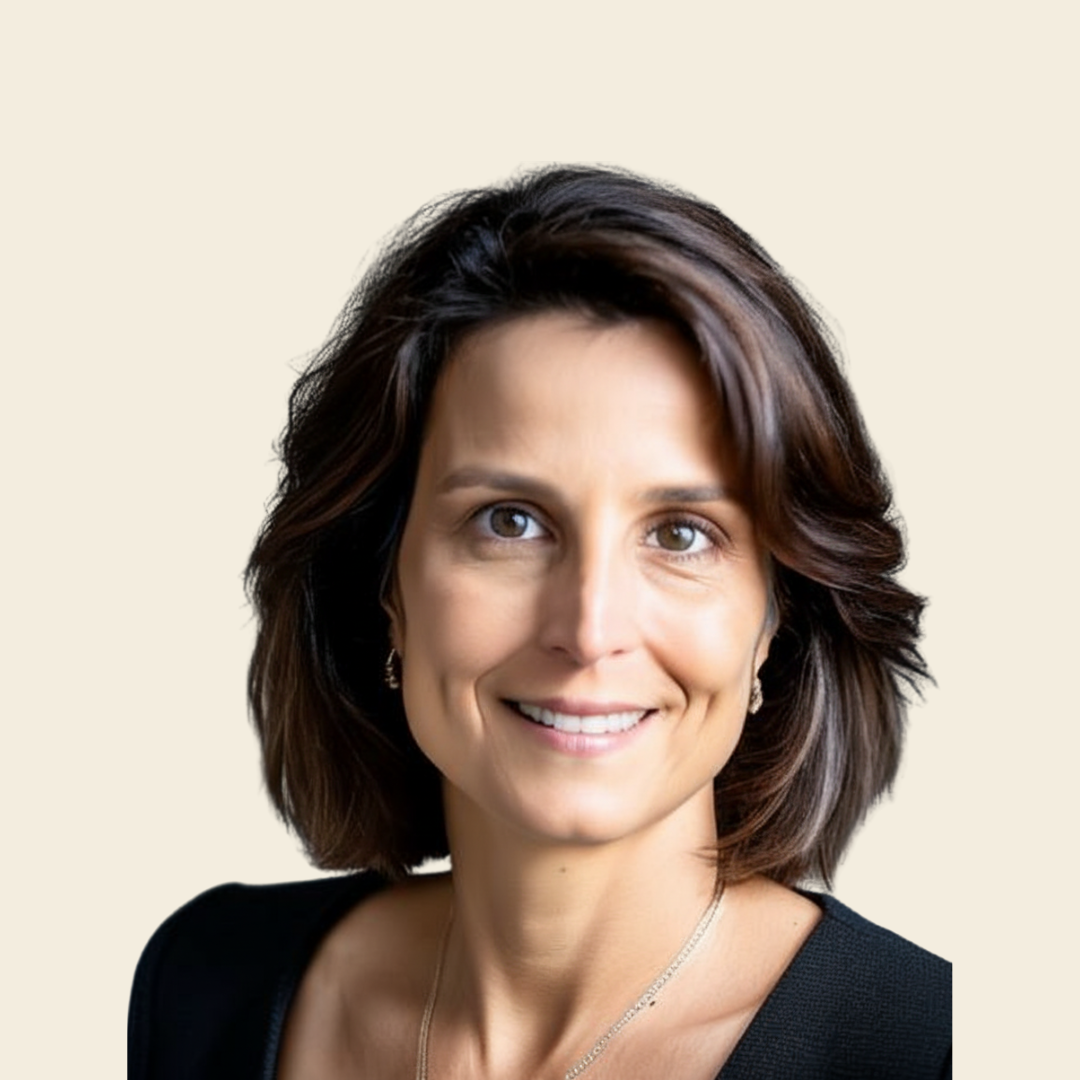 Portrait of a woman with shoulder-length brown hair and light skin, smiling against a light neutral background.