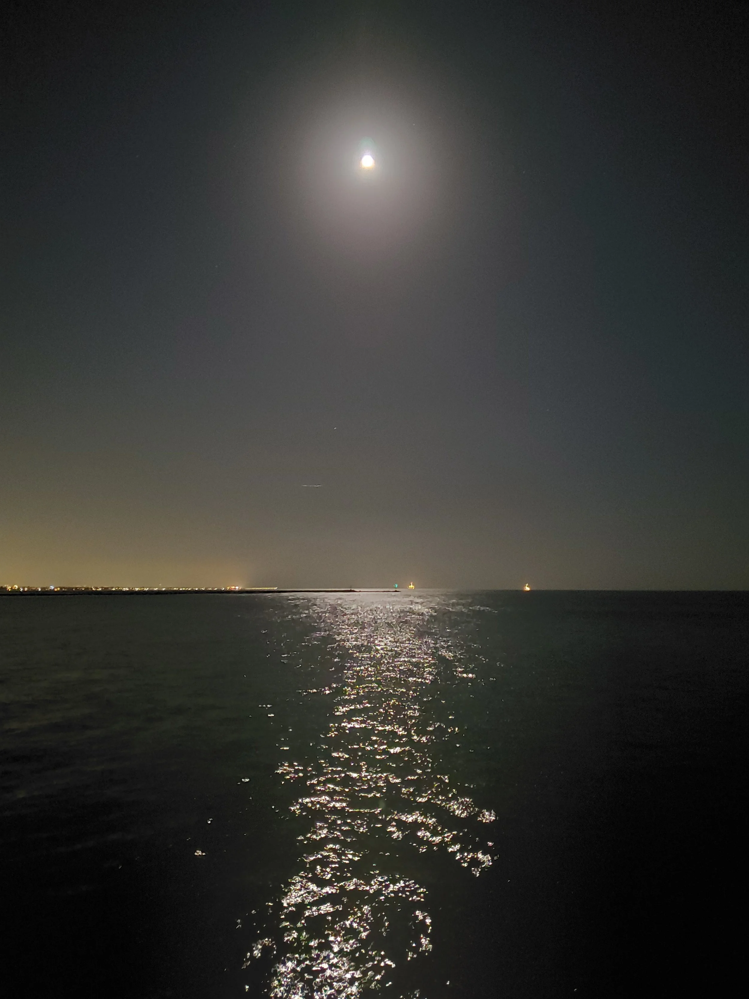 Bright moonlight reflecting over the ocean from the pier in Seal Beach