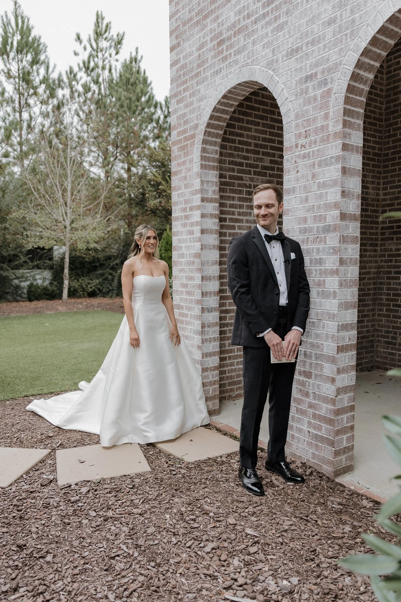 Bride walking toward groom for their wedding first look at The Bradford in New Hill, NC