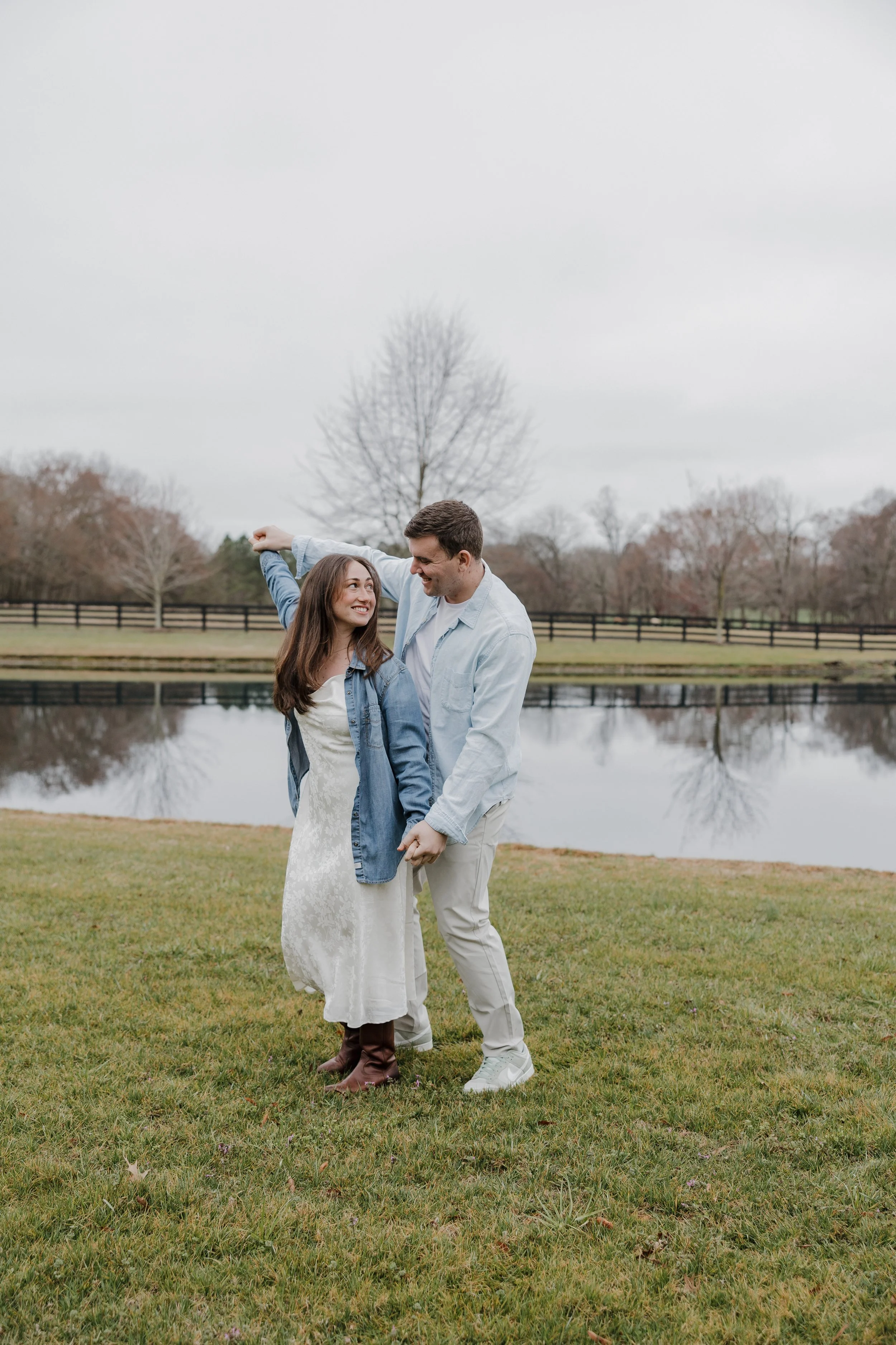 Candid engagement portrait of Danielle and Greg laughing together at Morning Glory Farm