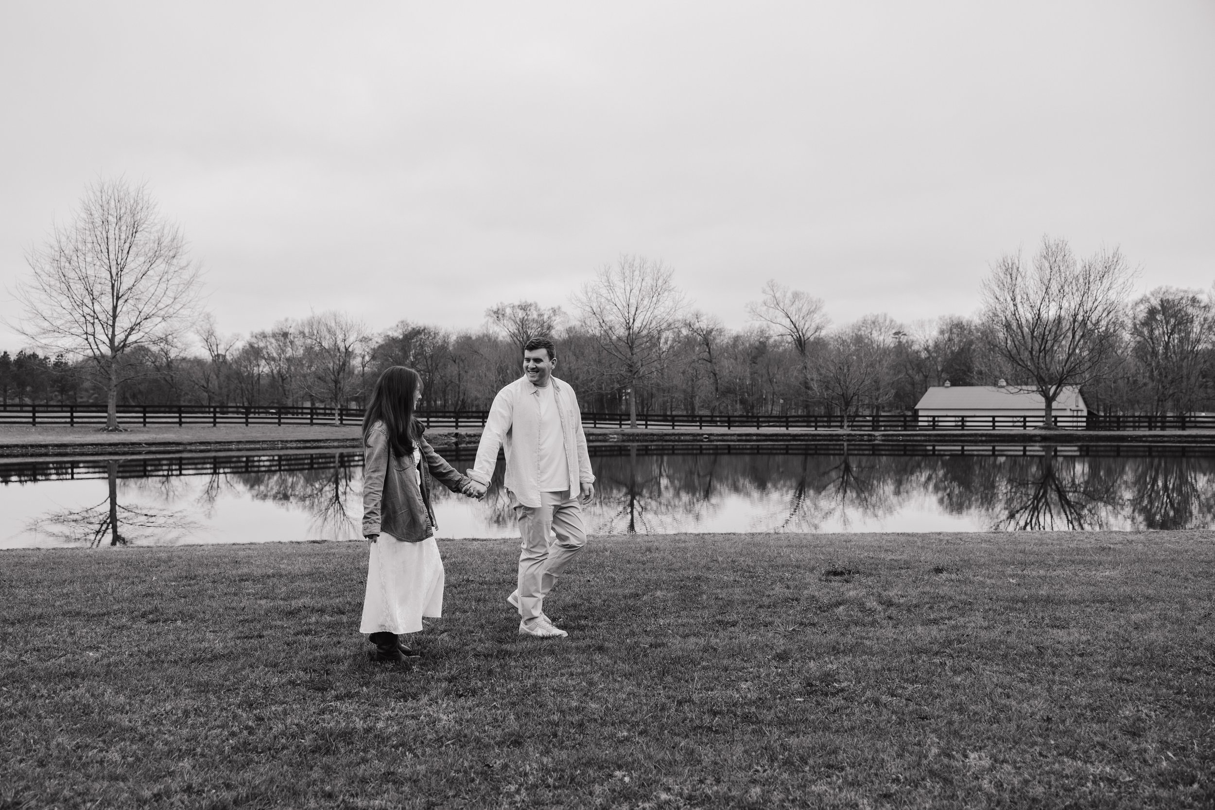 Engaged couple walking hand in hand through the fields at Morning Glory Farm in Charlotte, North Carolina