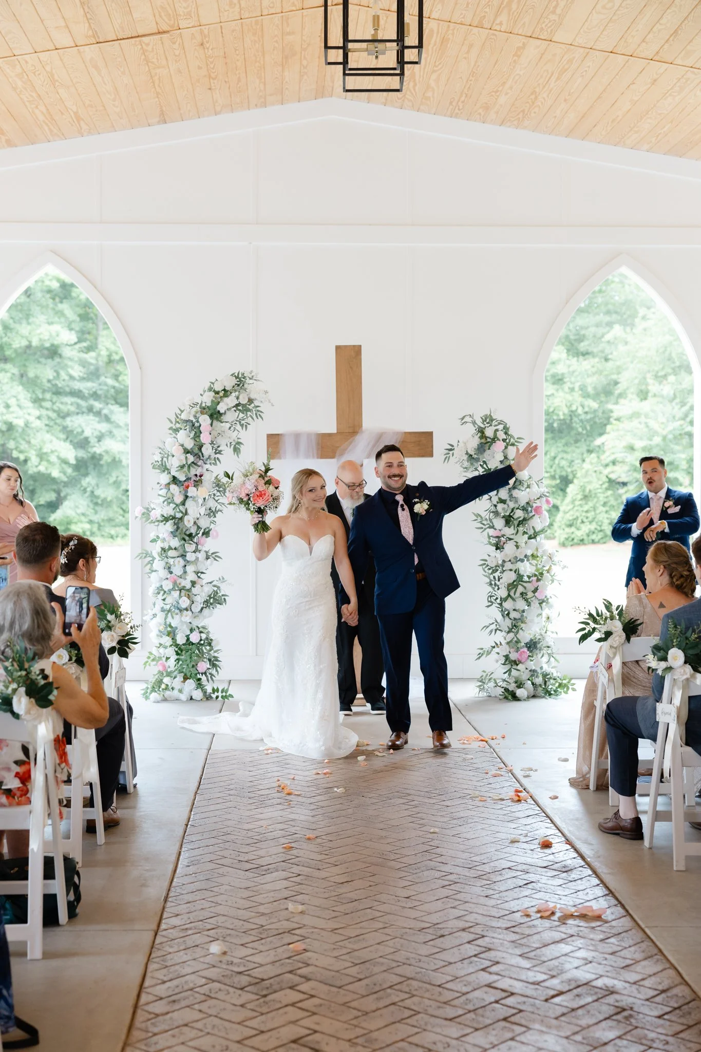 Joyful newlywed exit at The Hartwood surrounded by family and friends after an intimate wedding