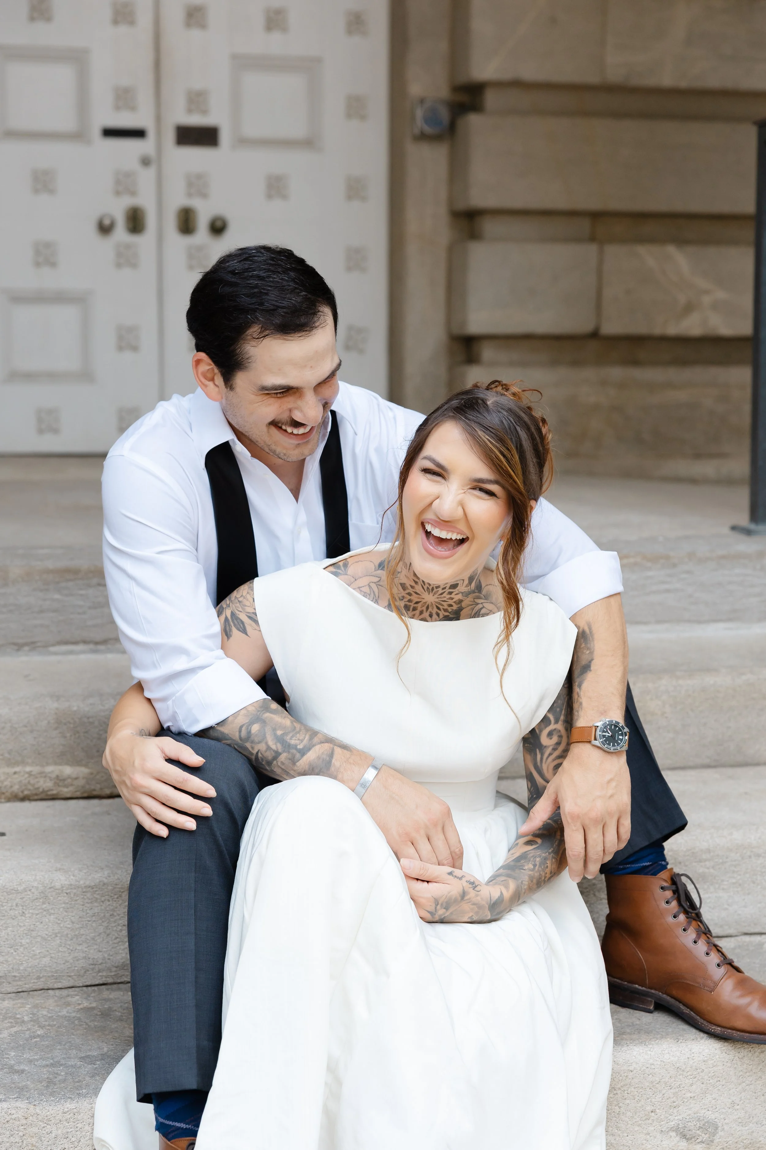 Couple laughing together during their downtown Raleigh engagement session