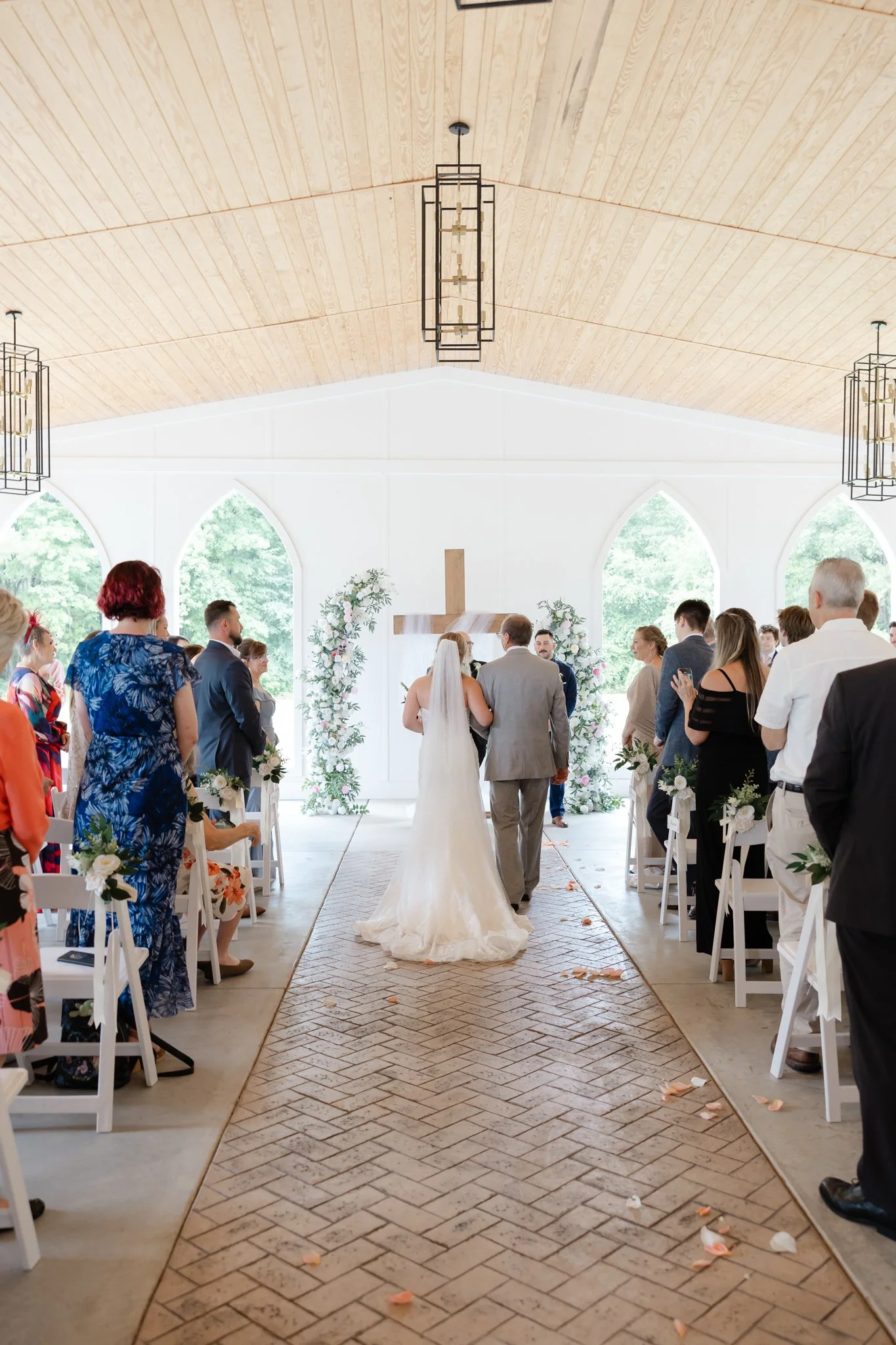 Documentary wedding photography of the bride walking down the aisle at The Hartwood wedding venue
