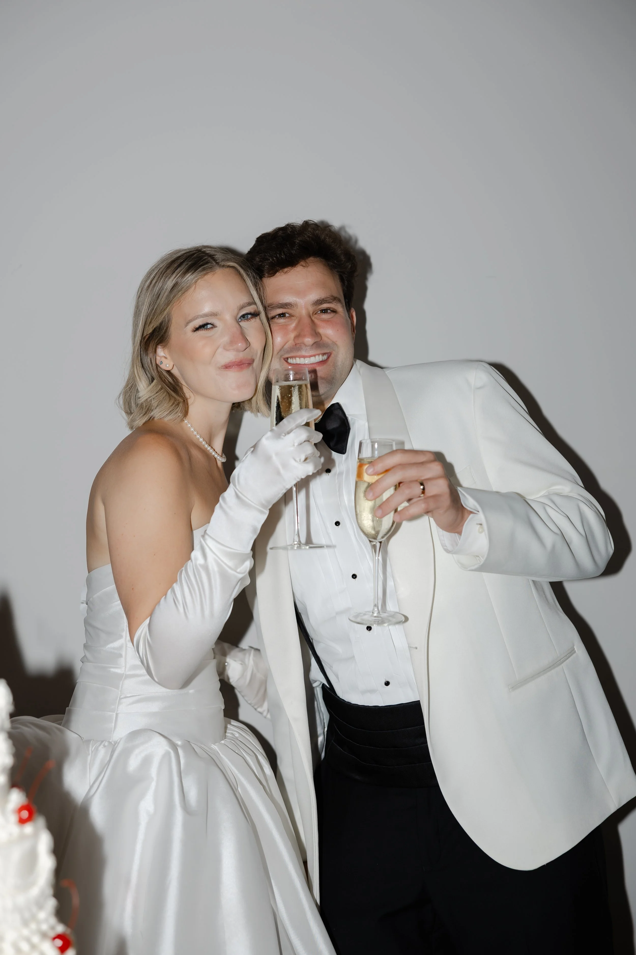 Newlyweds celebrating with champagne tower during North Carolina wedding reception