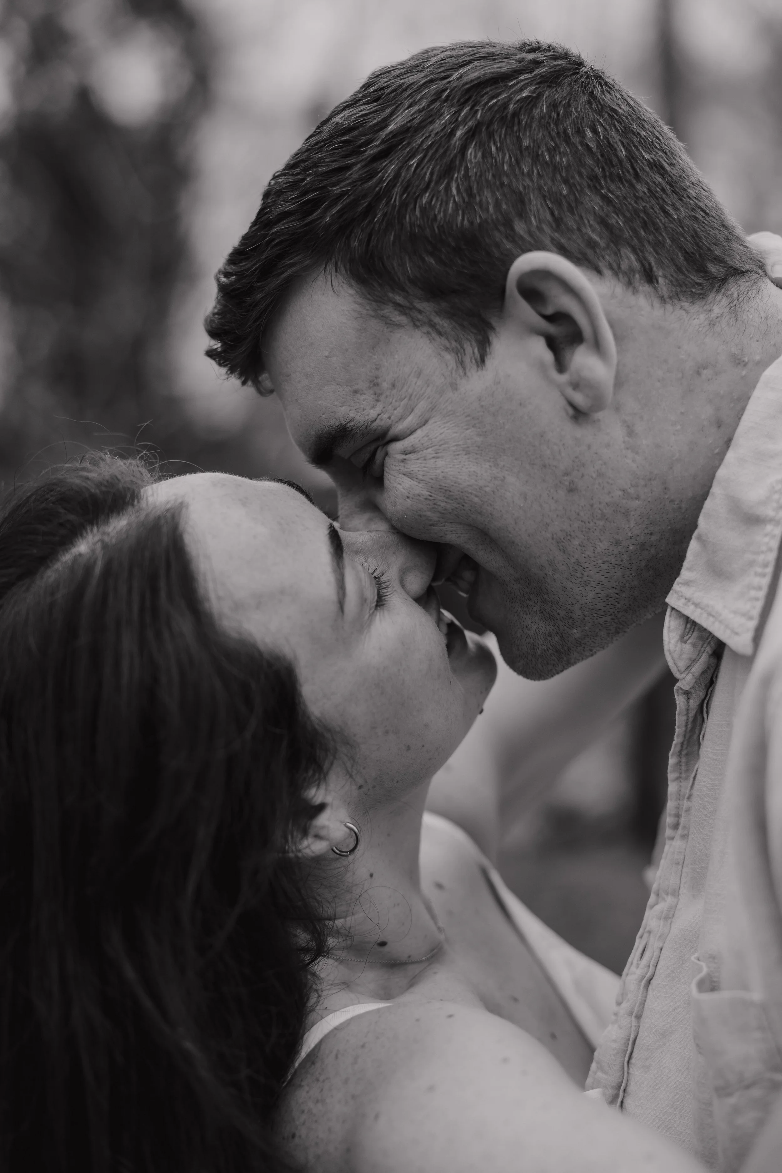 Close-up engagement portrait of Danielle and Greg smiling together during their Charlotte engagement session