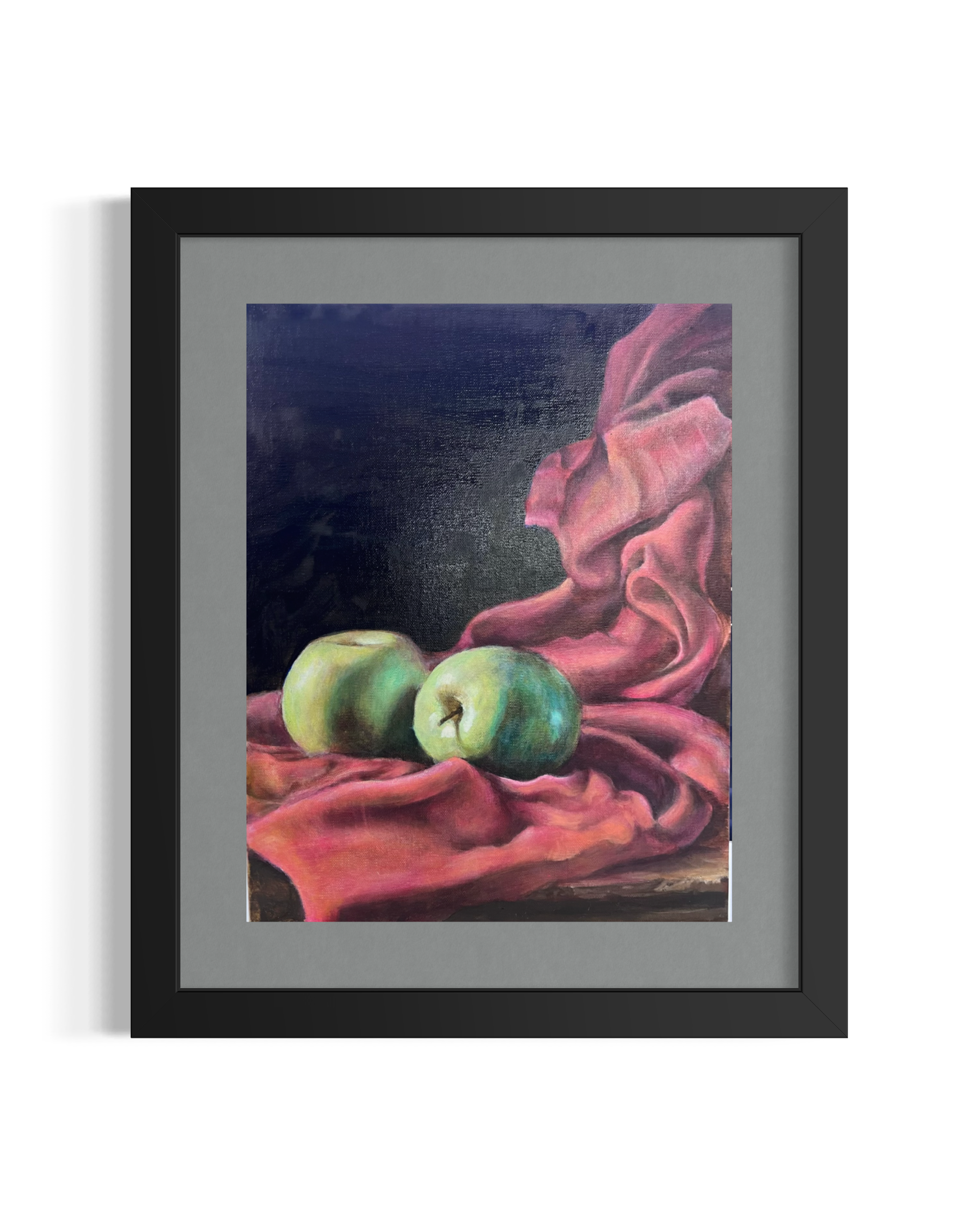 Close-up of a framed still life painting depicting red and pink roses with three green apples on a cloth, dark background.