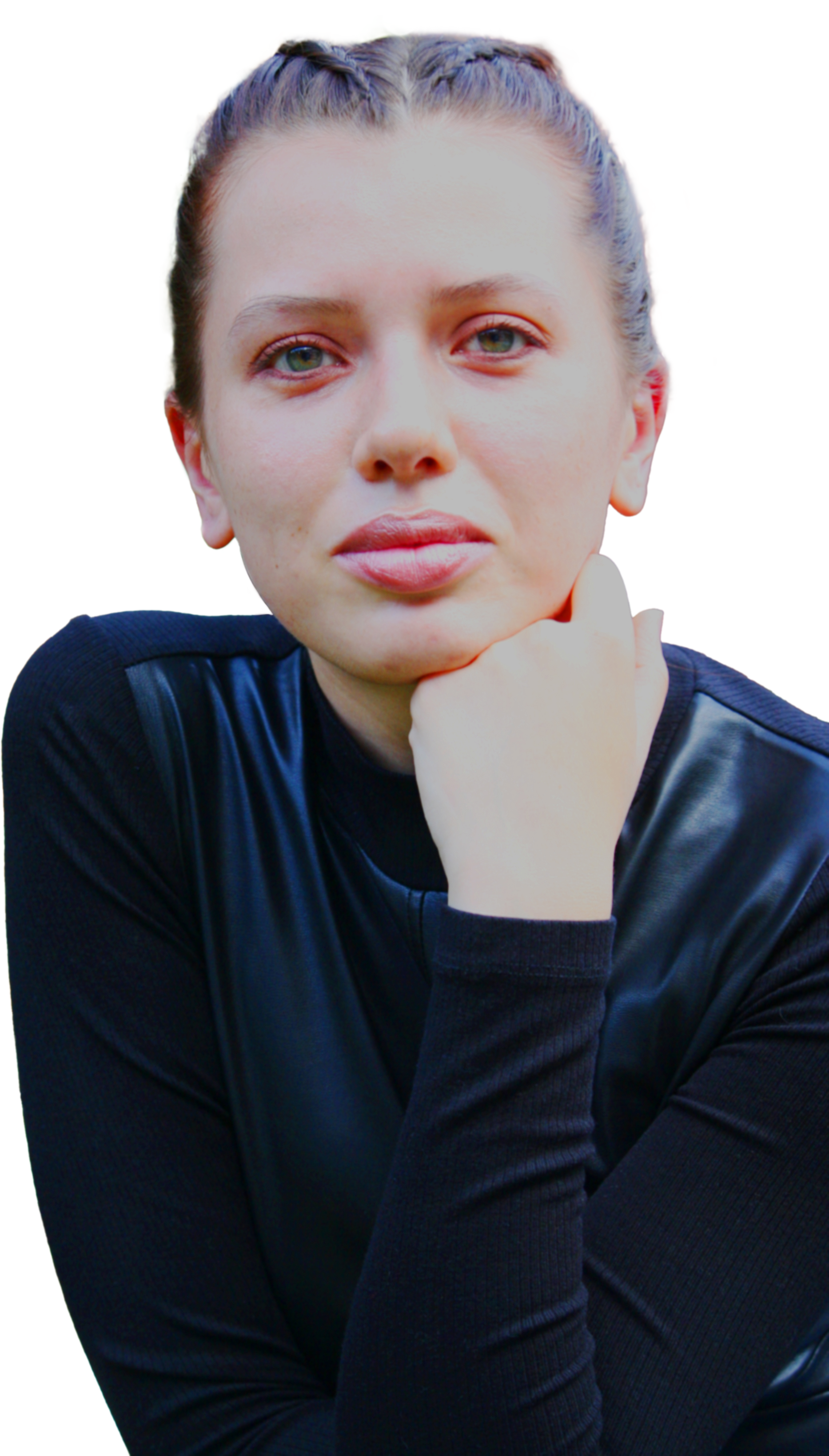 Portrait of a young woman with braided hair, wearing a black long-sleeve top, resting her chin on her hand, against a white background.