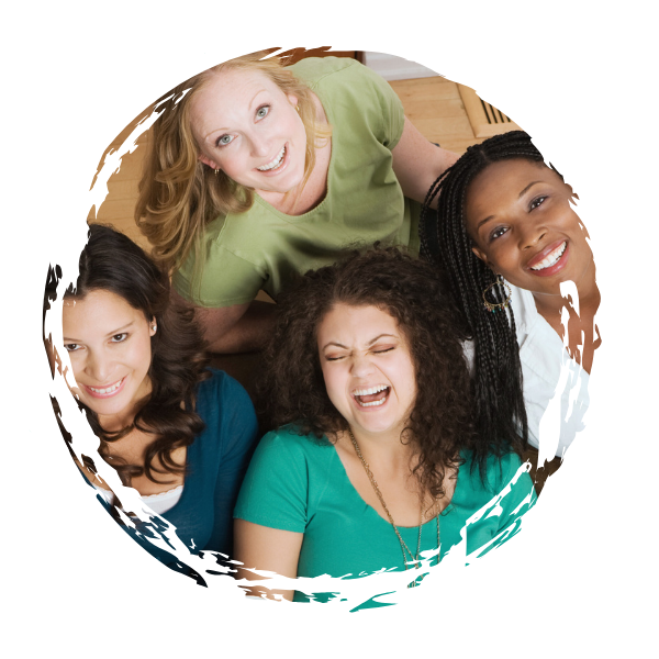 A group of four women smiling and laughing together indoors, viewed from above.