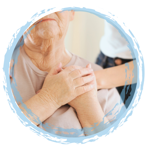 Close-up of an elderly woman holding her chest with both hands, receiving Reiki.