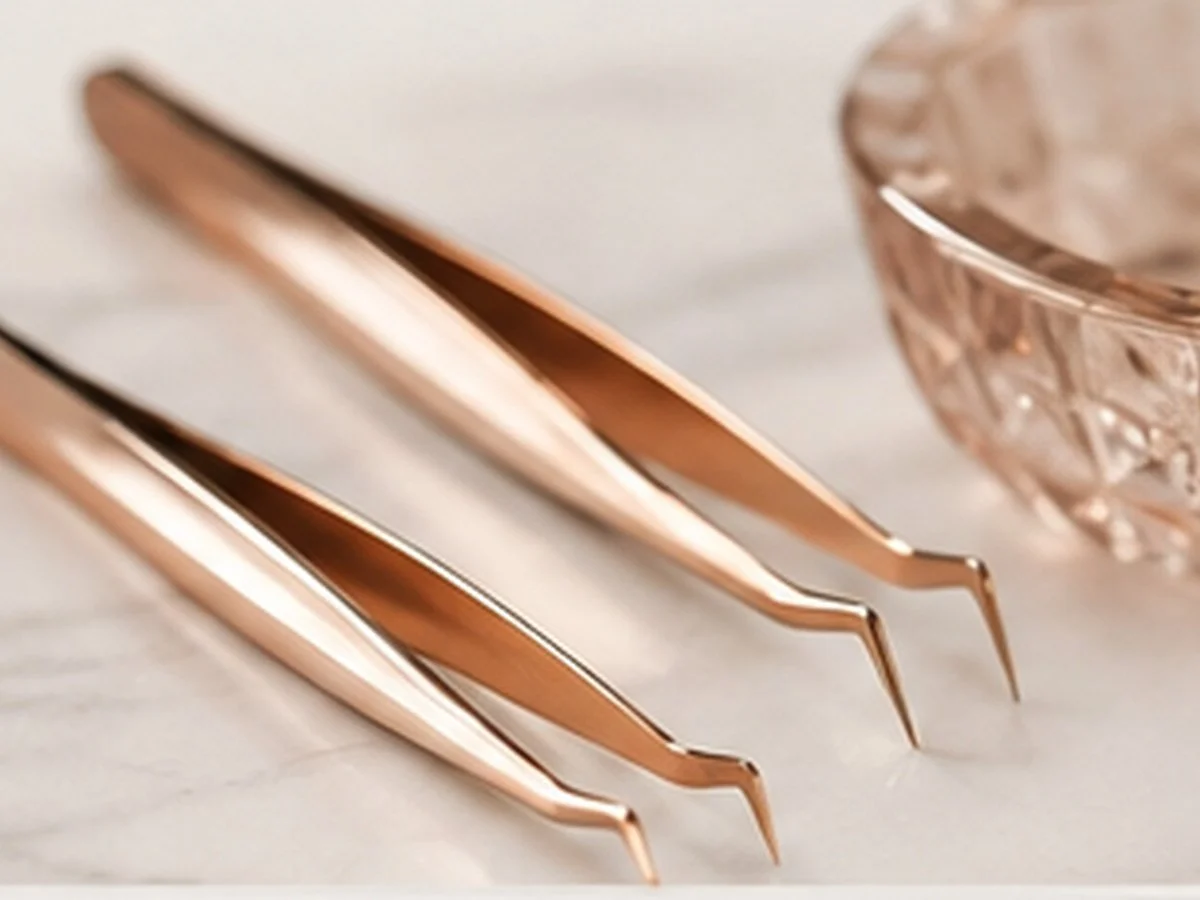 set of three rose gold cuticle pushers and a small decorative rose gold bowl on a light surface