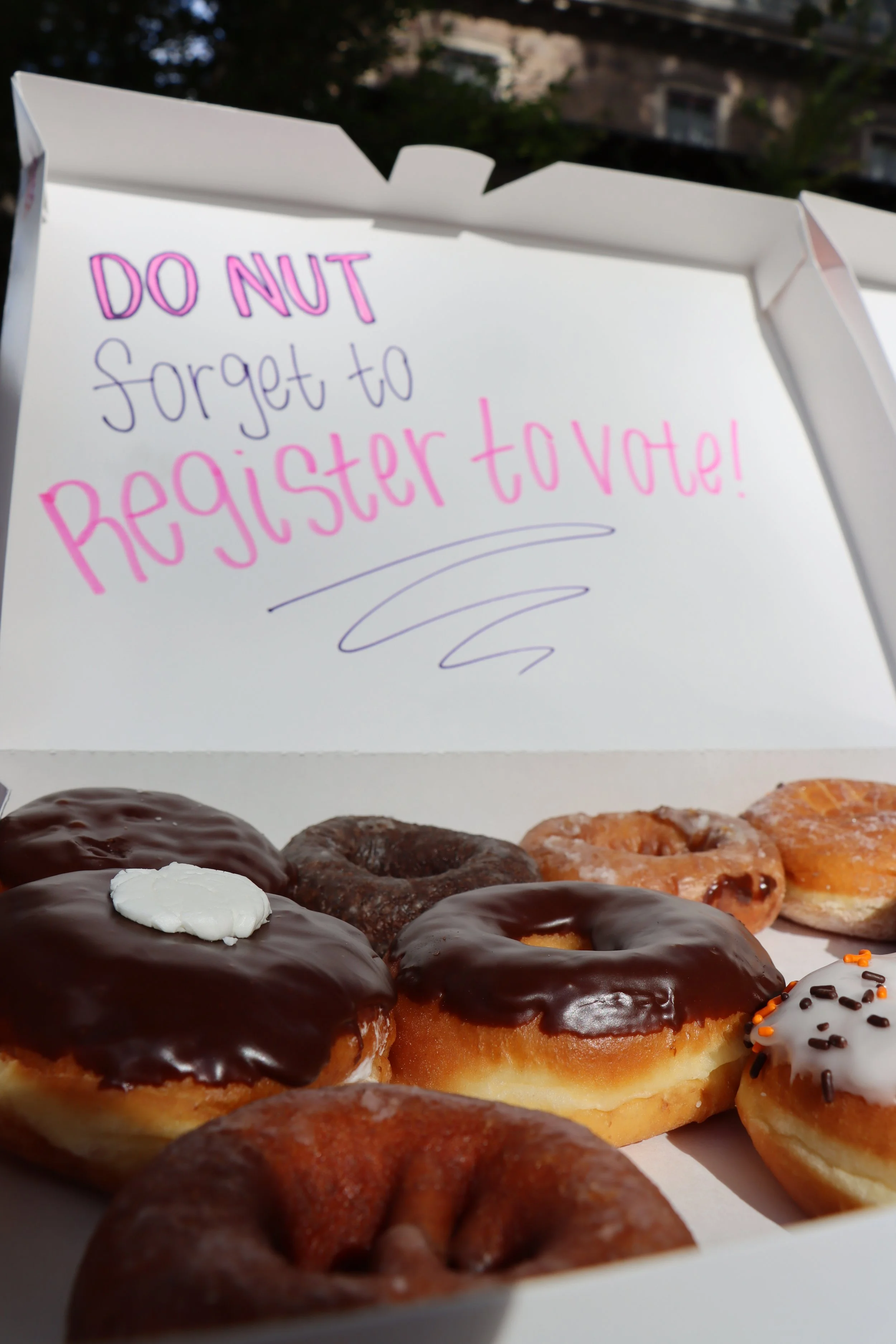 A donut box with "Do nut forget to register to vote" written on the back of it