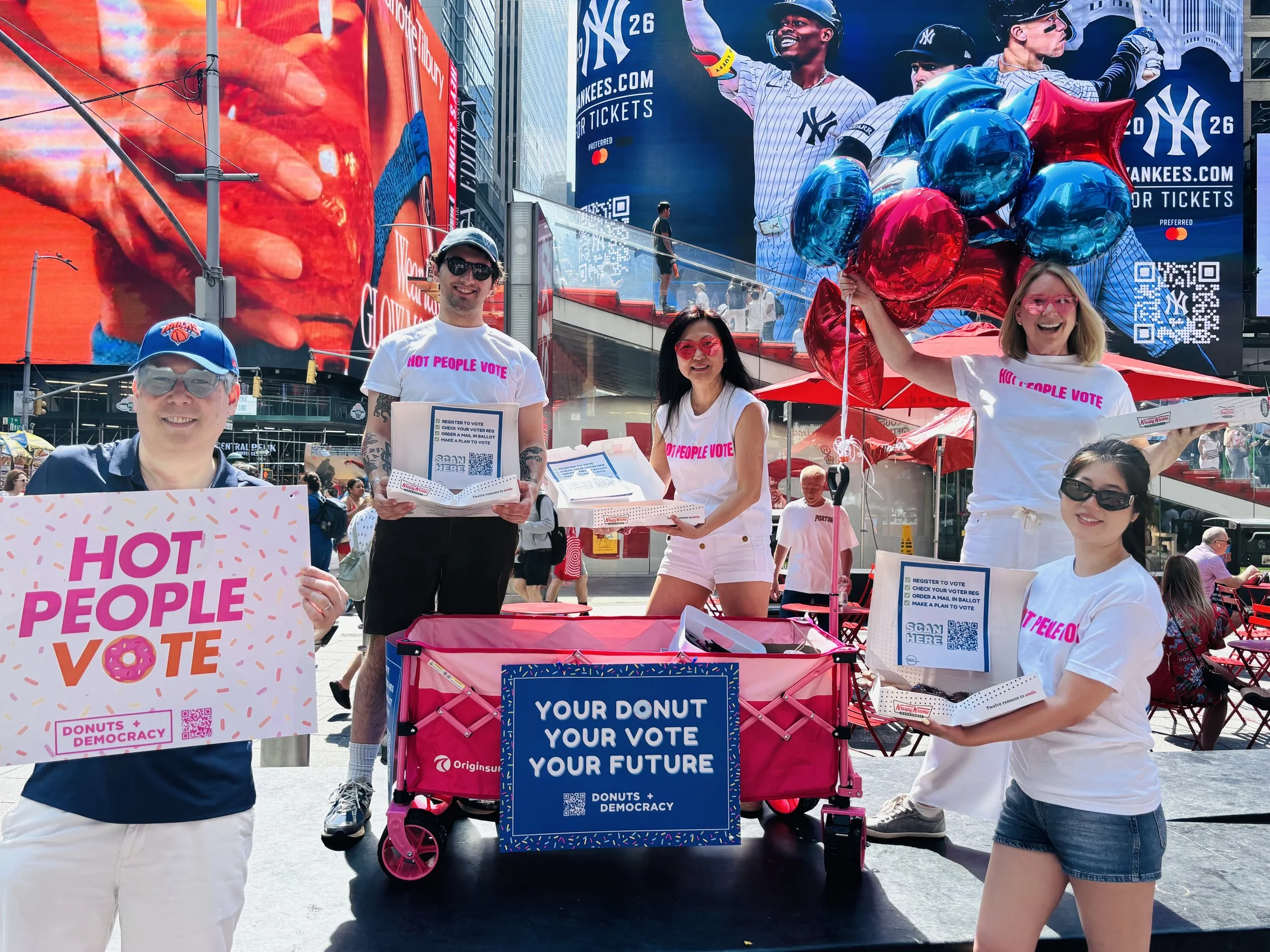 4 people in "hot people vote" shirts with a donut wagon