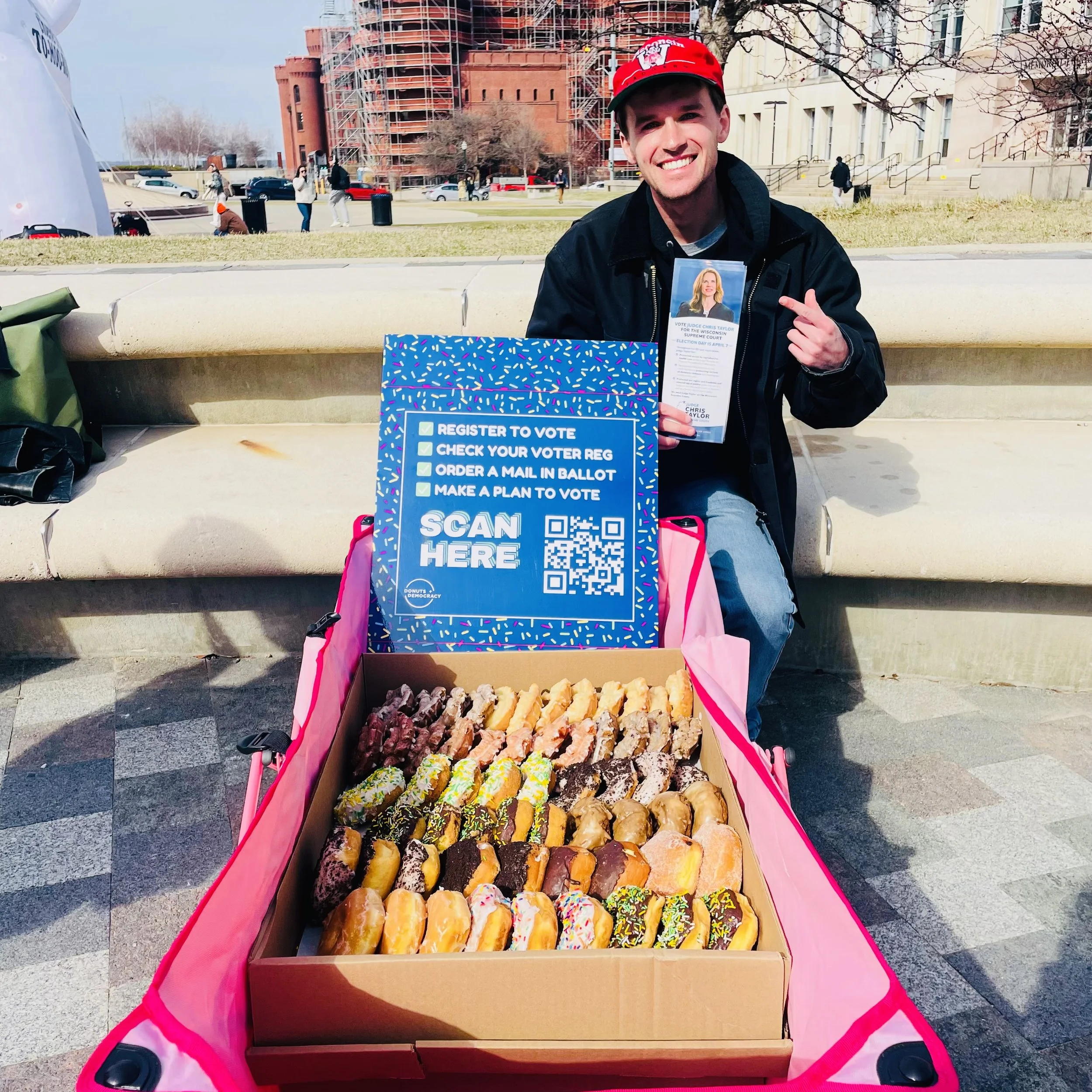 A person in front of a full donut wagon
