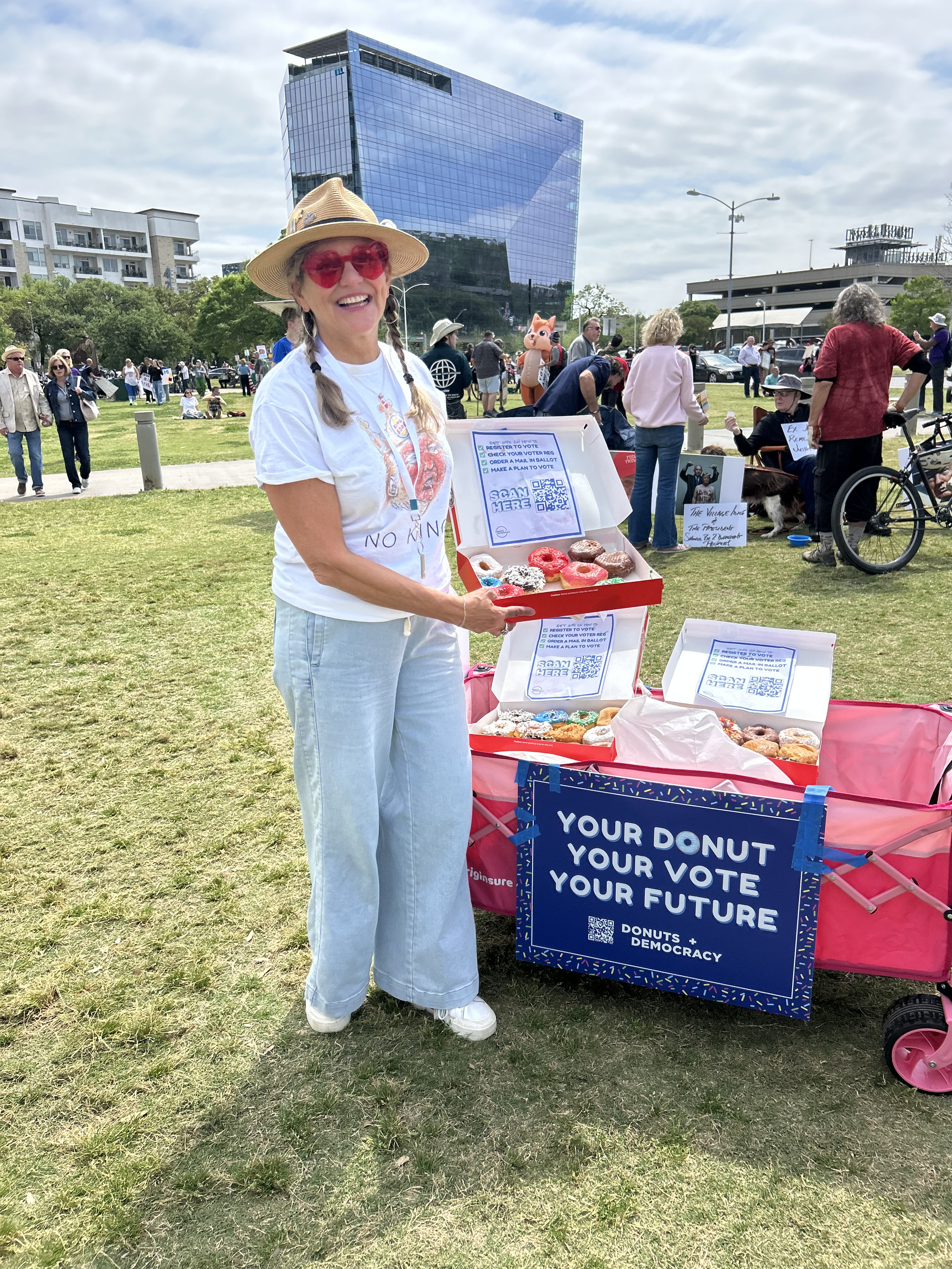 One person holding a donut box in front of a donut wagon