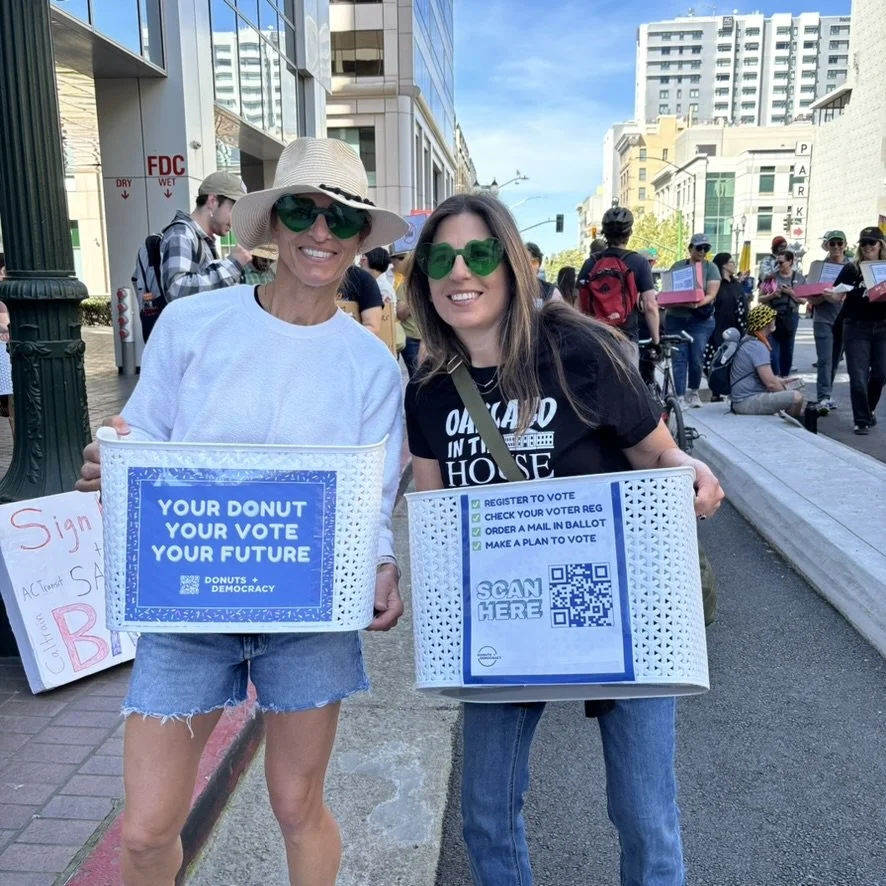 Two people with bins and registration signs