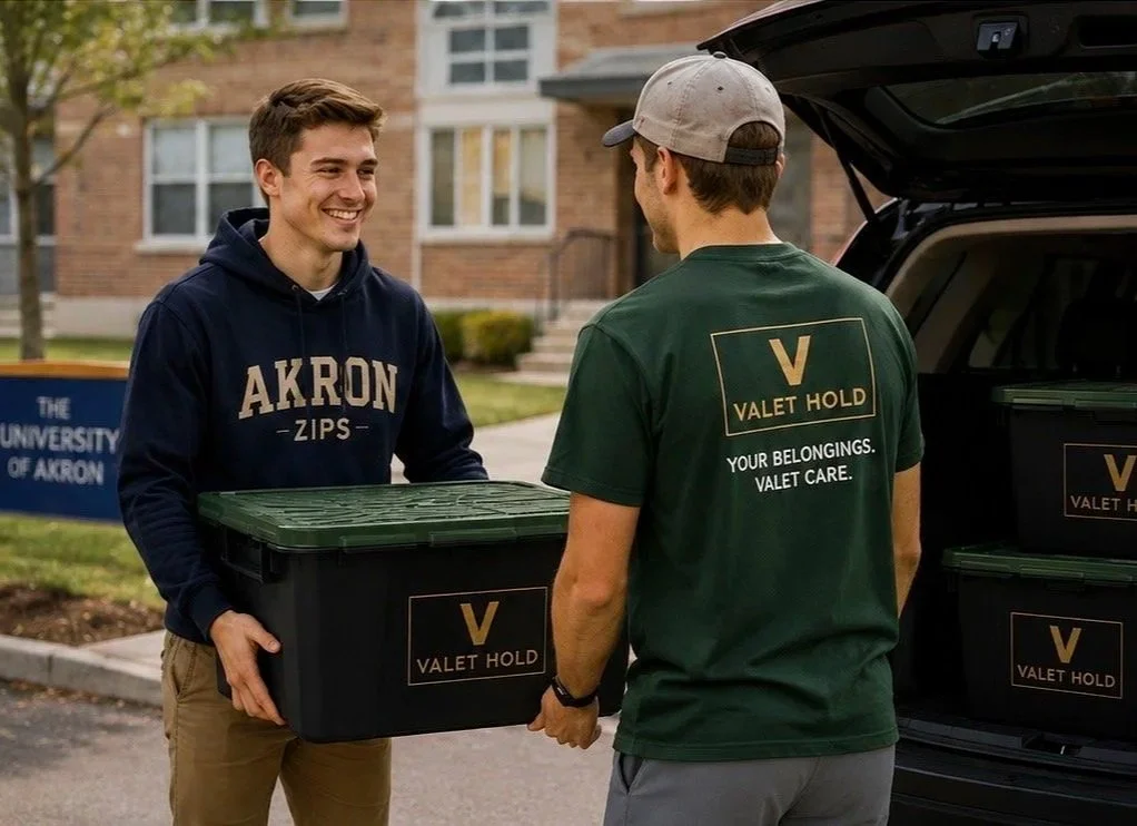 Person handing a Valet Hold storage tote to a team member beside an open SUV