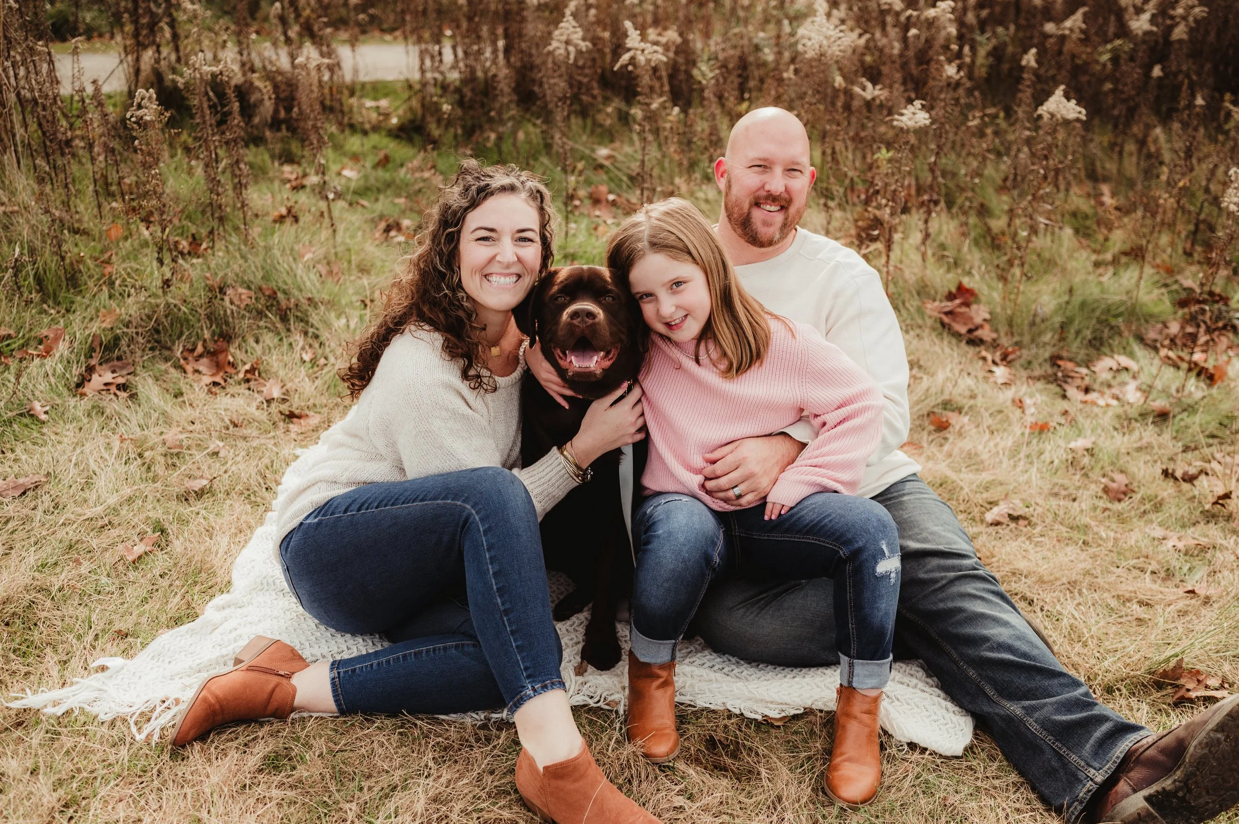 Valet Hold owners Matt and Jennie Williams with their family and dog outdoors.