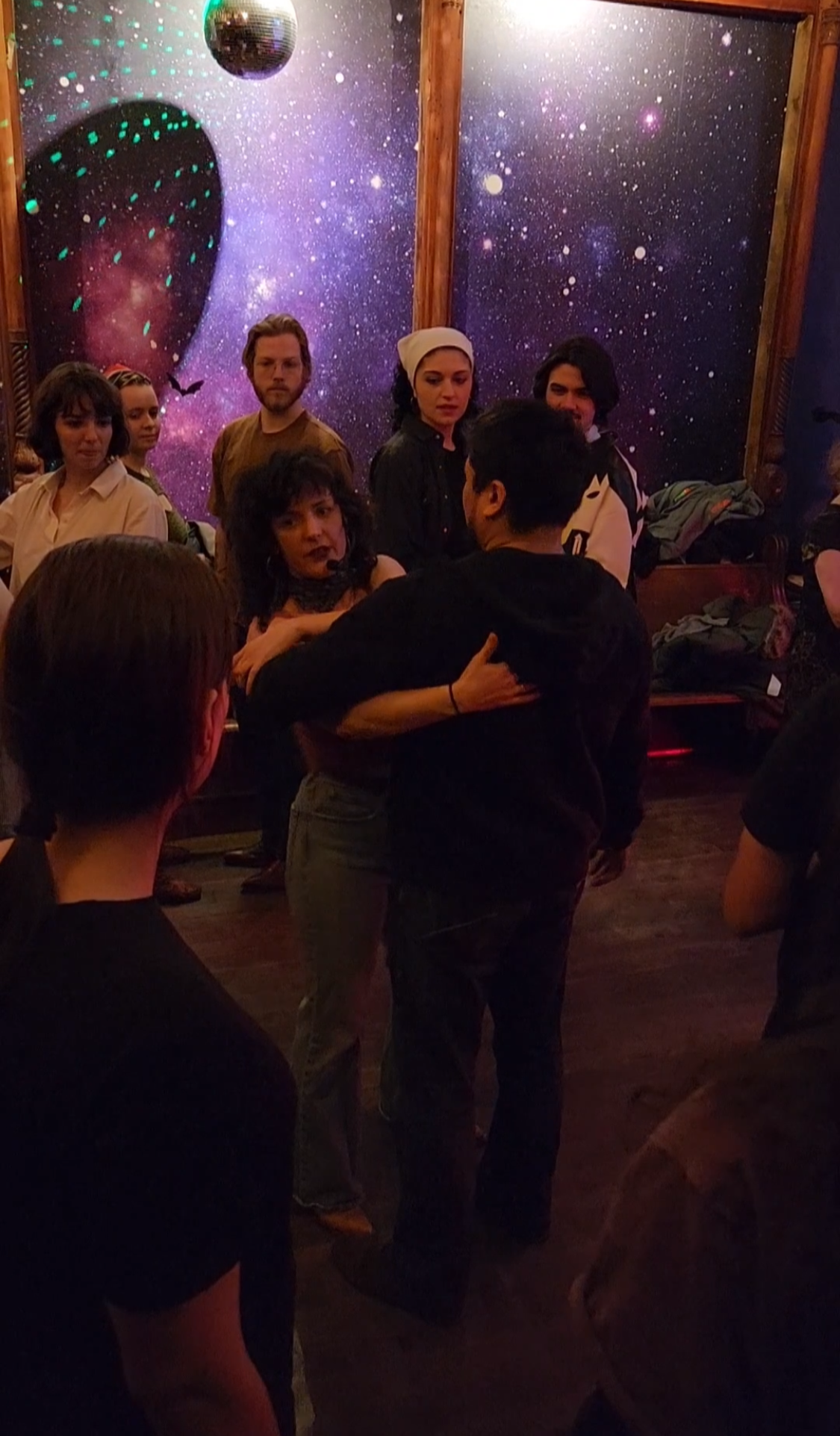Monthly Stompin at Starr Bar in Bushwick Brooklyn - 2Step & Line dance instruction followed by a dance, with a background featuring a galaxy and star pattern on the wall.
