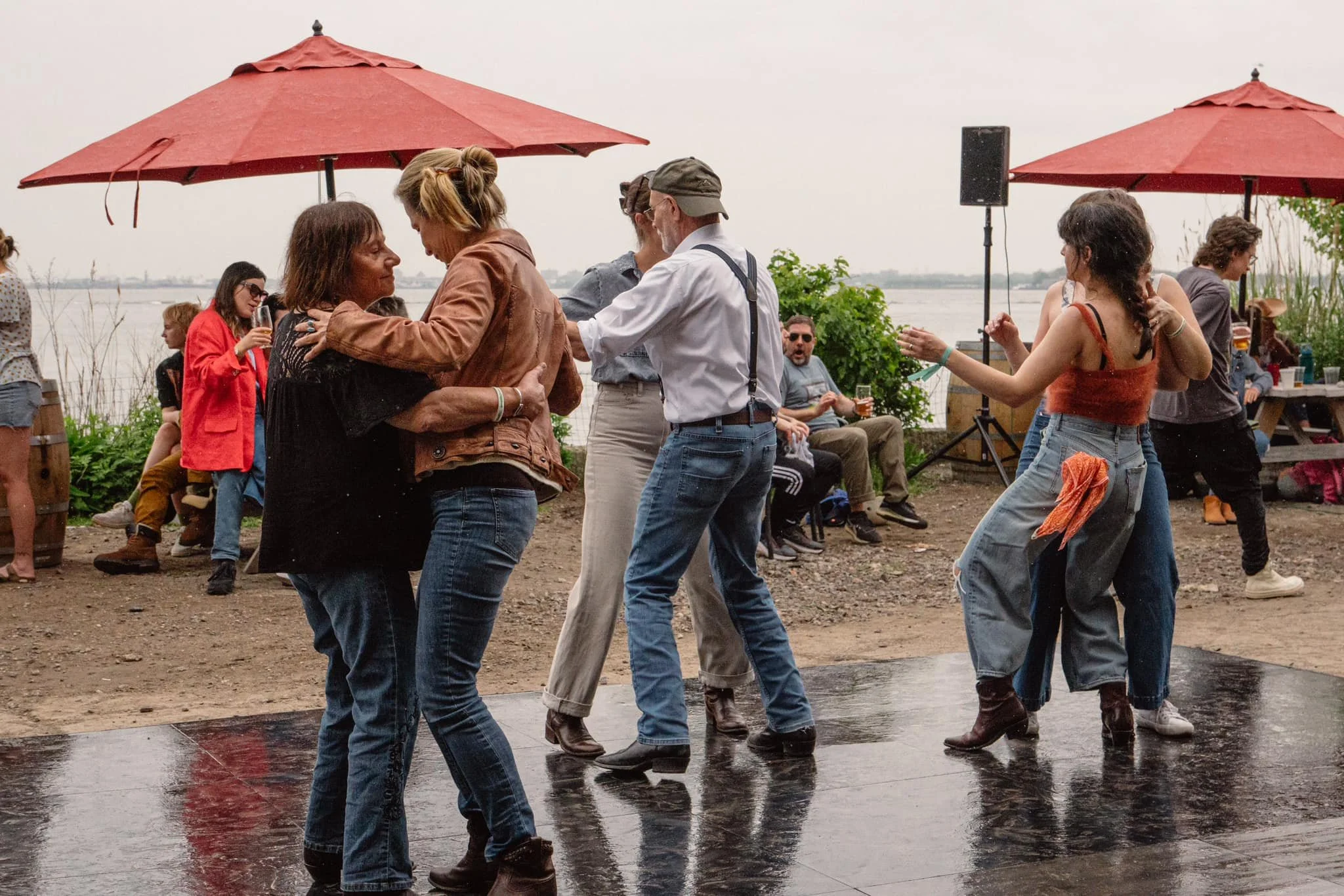 Swamp in the City Cajun & Zydeco Festival - a group dances in a light rain on the Red Hook waterfront.