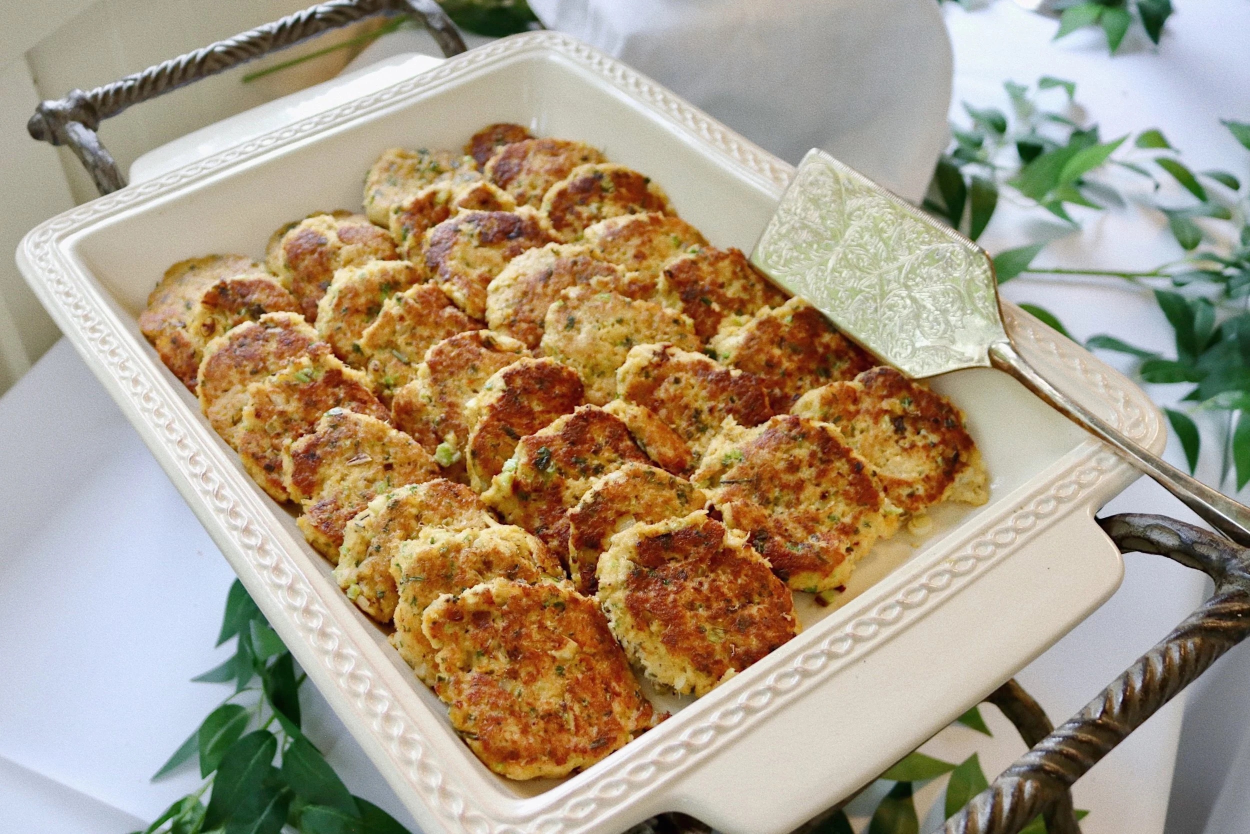 Cajun crab cakes served with Creole remoulade sauce and minced green onions, prepared by Silver Platter Catering