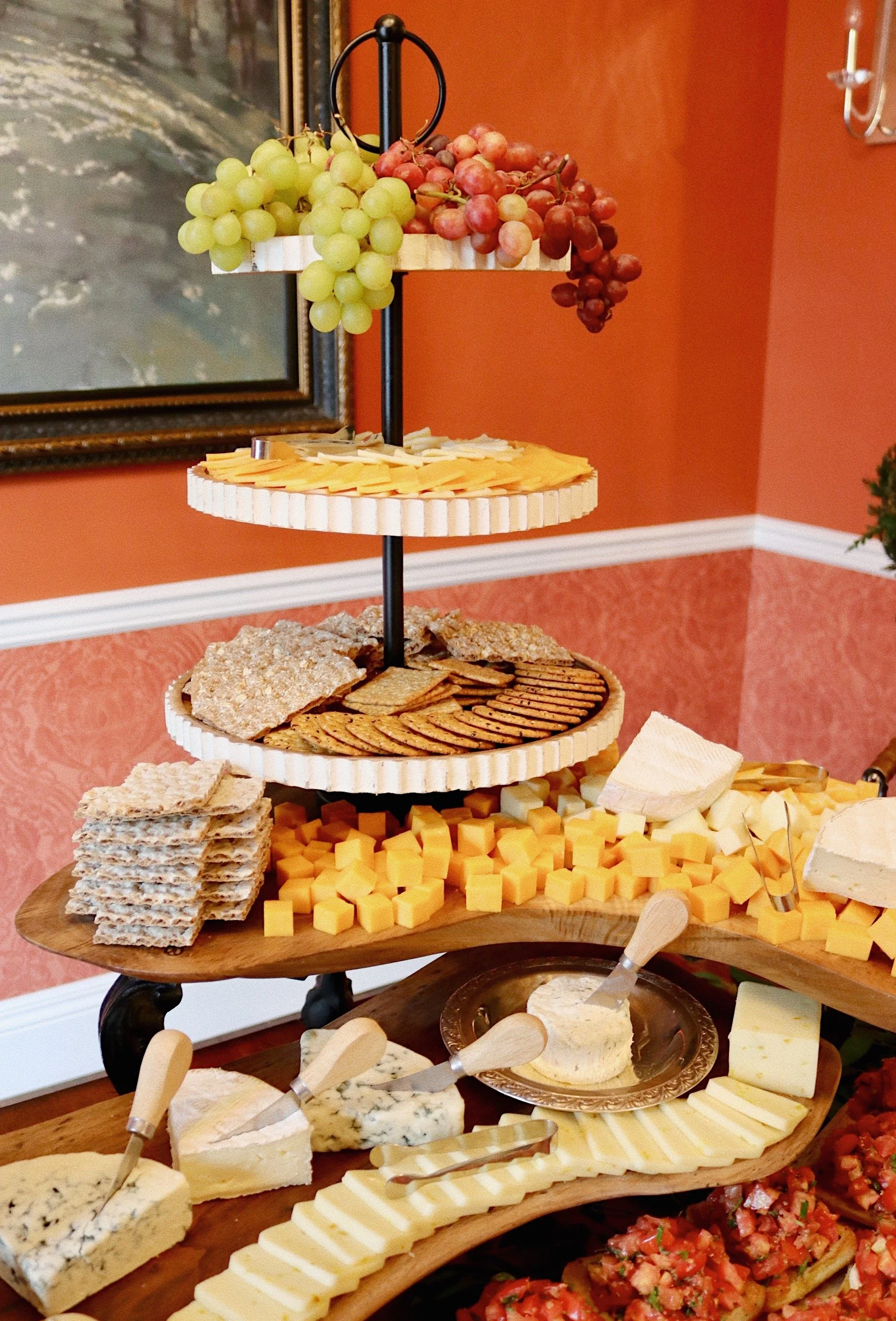 Assortment of cheeses, crackers, and grapes prepared and arranged by Silver Platter Catering