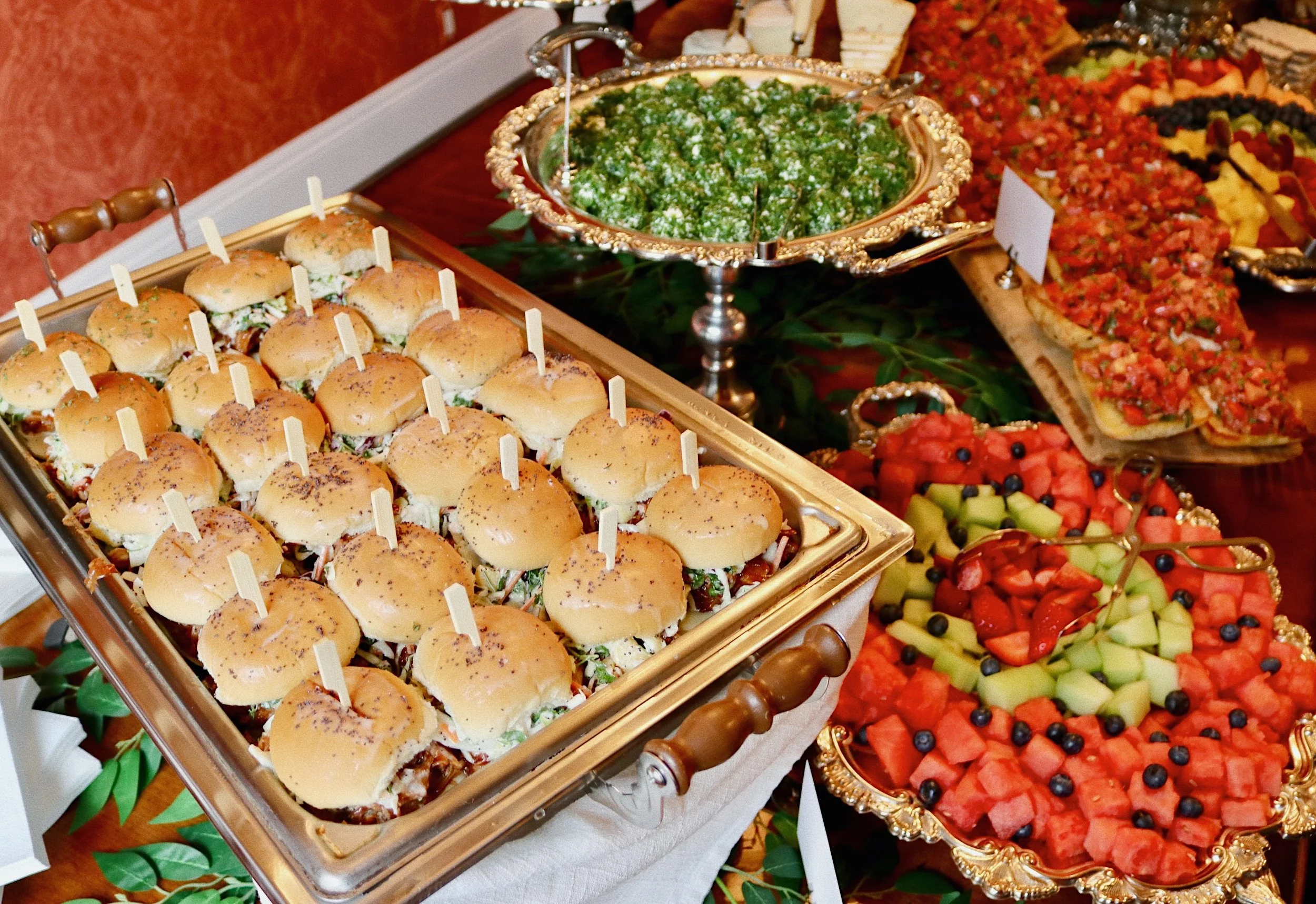 Pulled pork sliders with creamy pineapple, sweet onion, and poppy seed coleslaw, prepared by Silver Platter Catering
