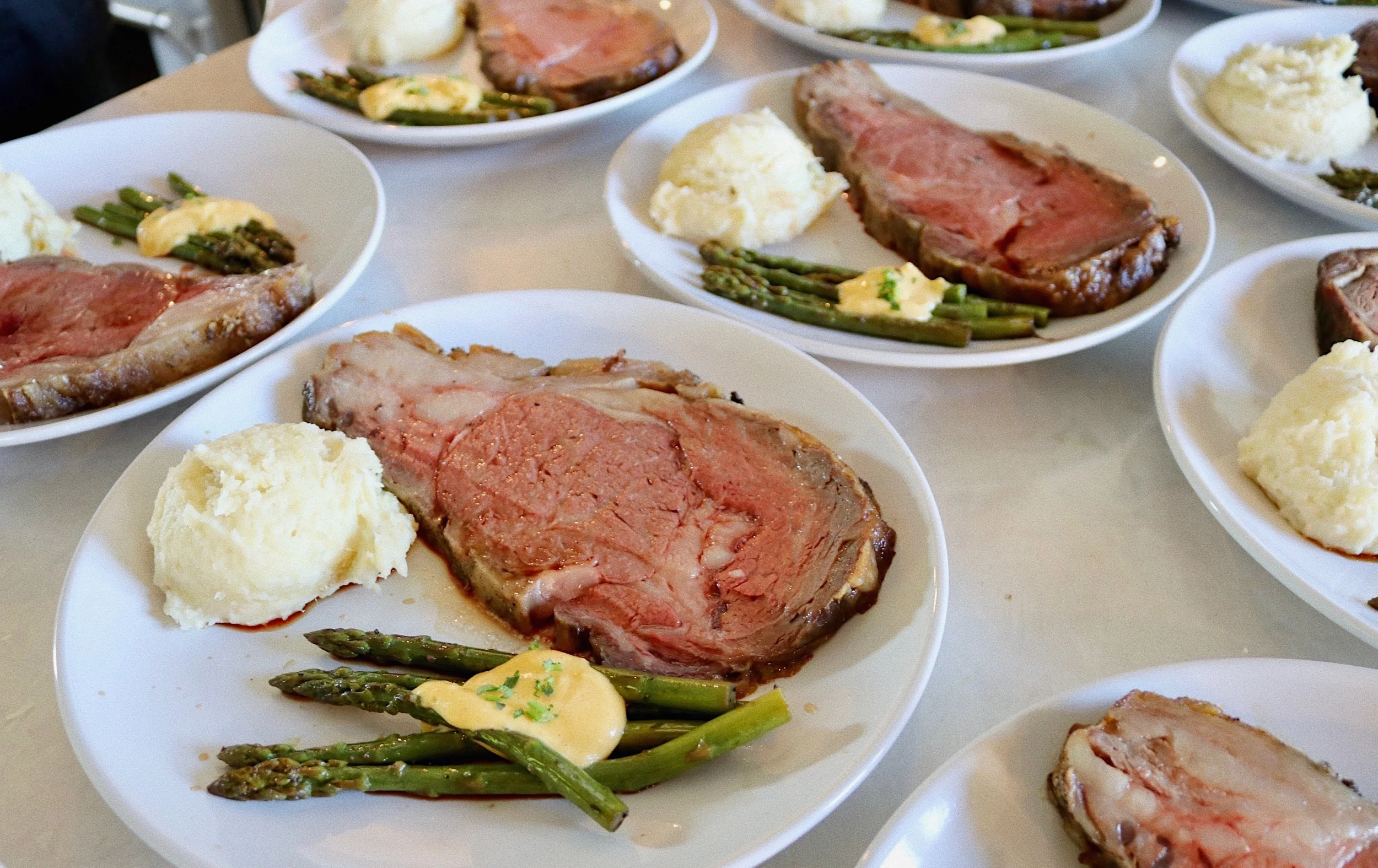 Plated prime rib dinner served with mashed potatoes and asparagus, prepared by Silver Platter Catering