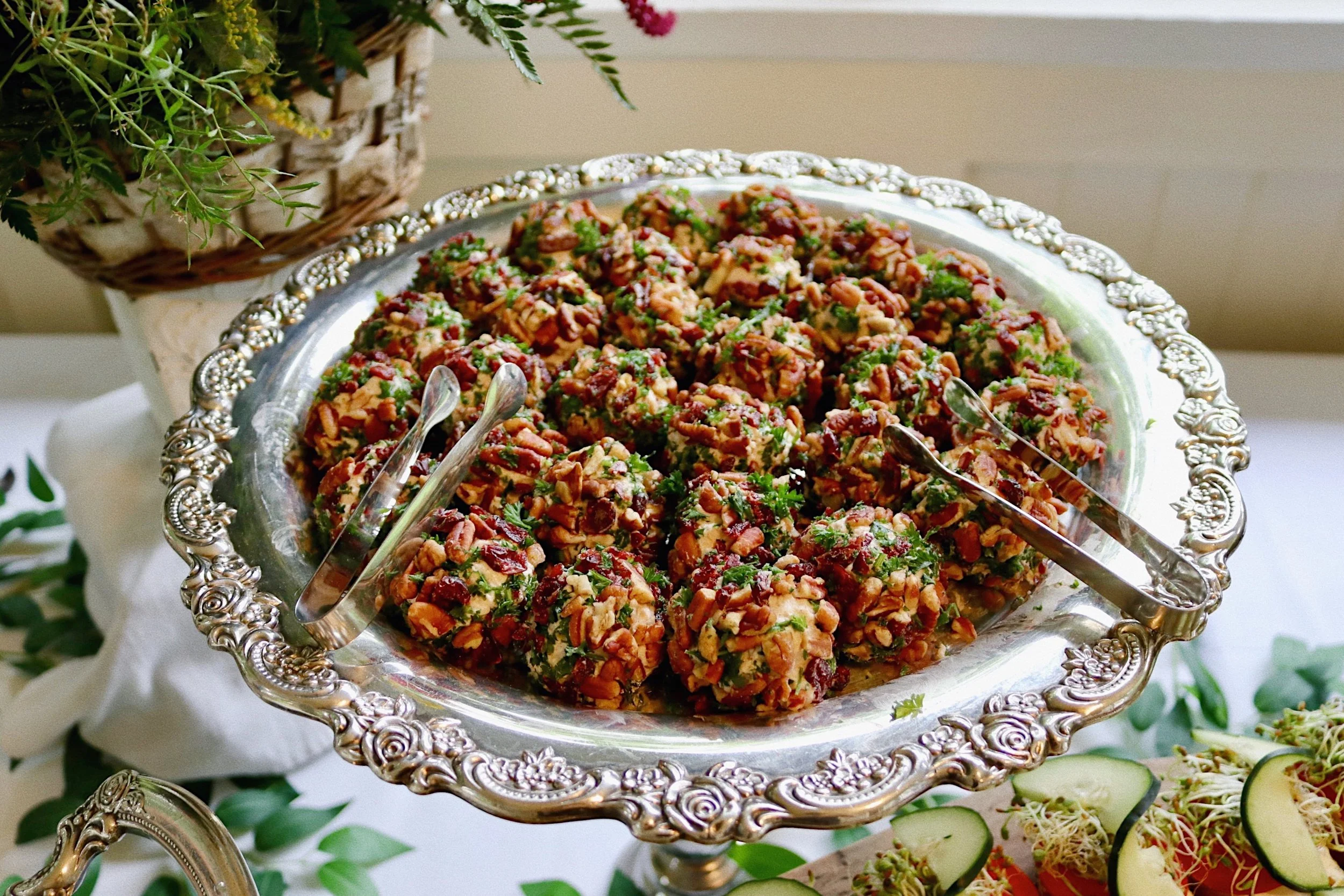 Goat cheese truffles rolled in toasted pecans, dried cranberries, and Italian parsley, prepared by Silver Platter Catering