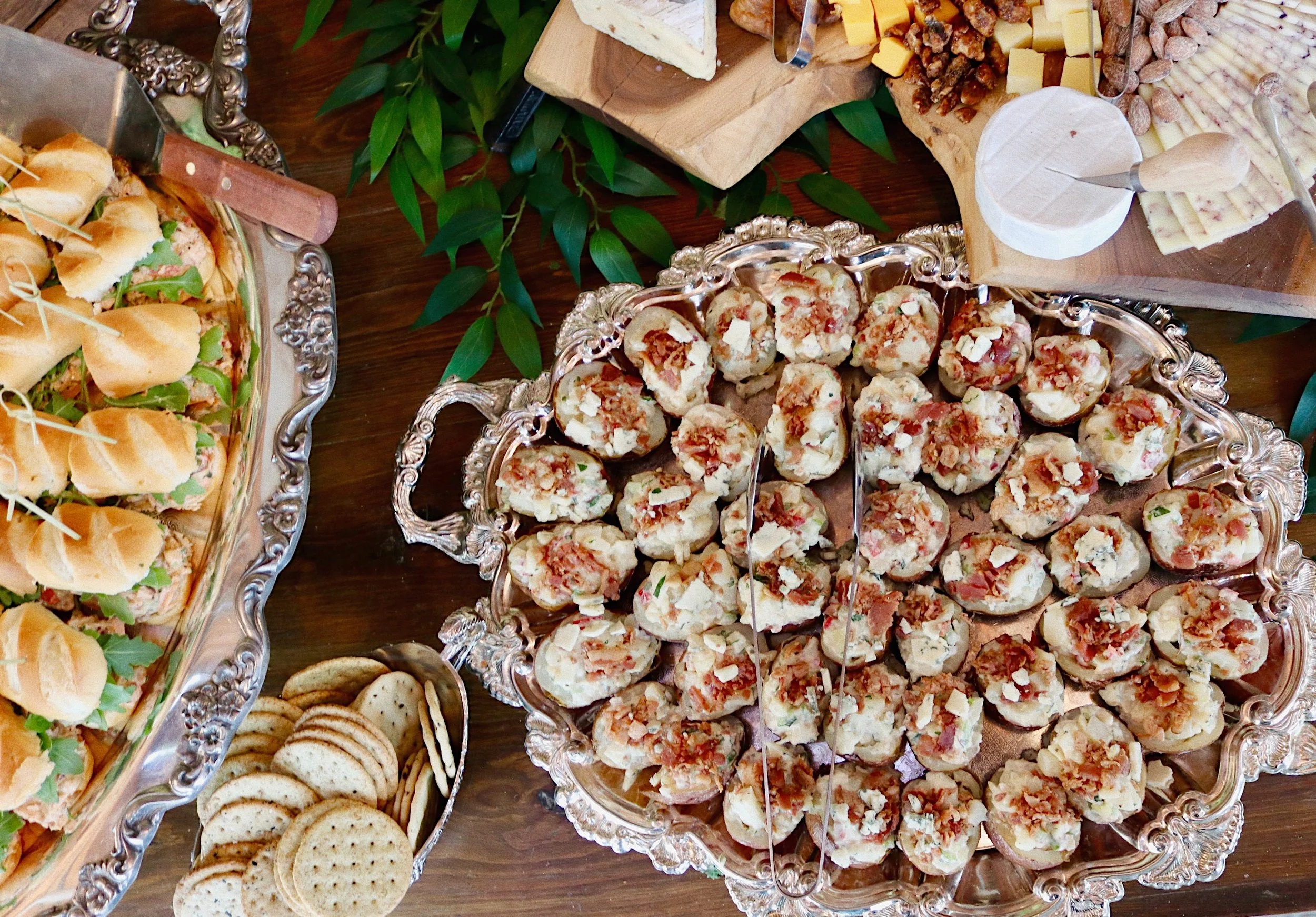 Mini stuffed baked potatoes topped with bacon, prepared by Silver Platter Catering