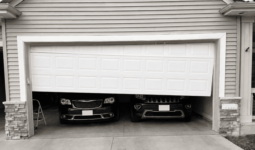 Misaligned garage door requiring maintenance and adjustment.